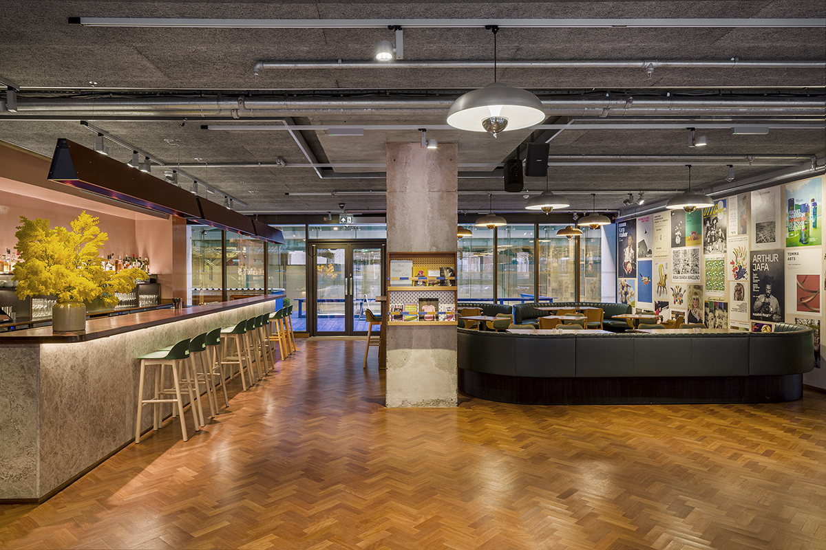 Modern event space at Toklas Restaurant with stylish bar and natural light.