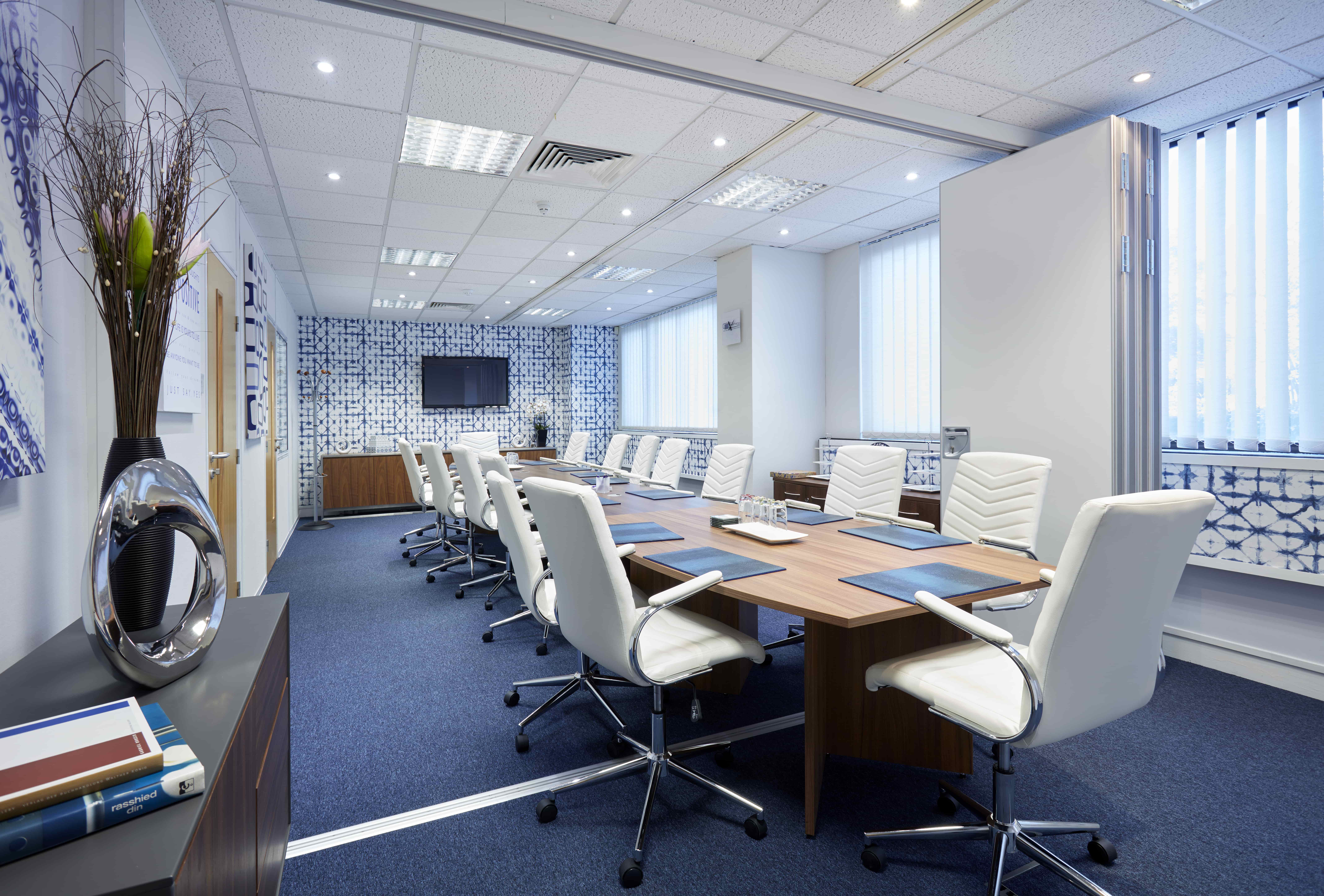 Modern conference room in Solar House with large table, ideal for corporate meetings.