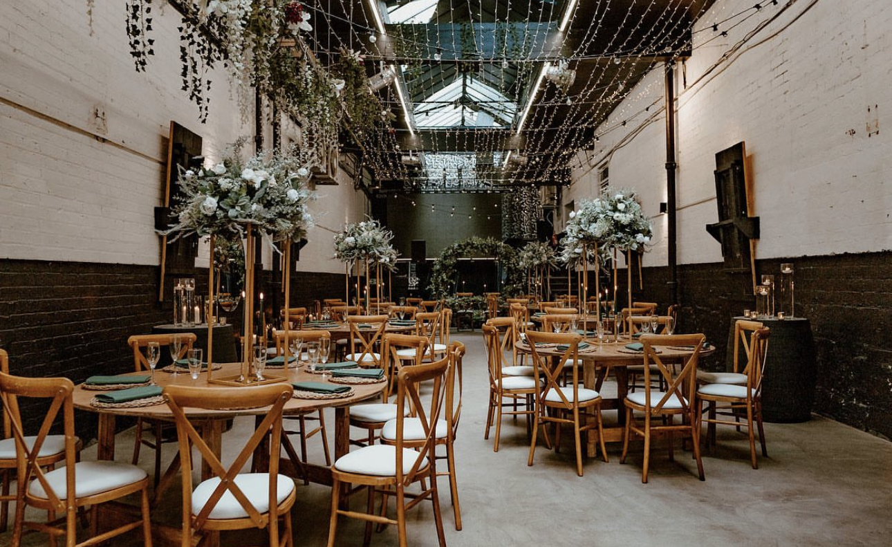 Elegant event space with round tables, floral centerpieces for weddings and gatherings.