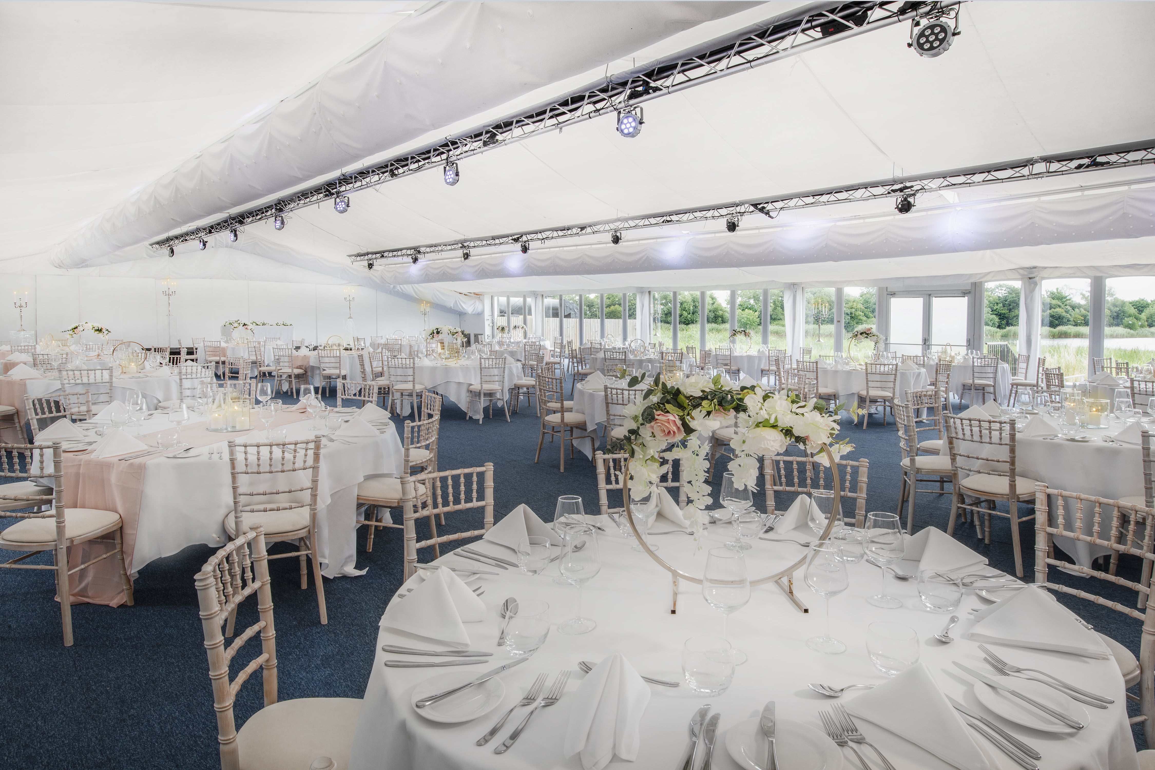 Whimbrel Marquee at De Vere Cotswold Water Park, elegant wedding venue with floral decor.