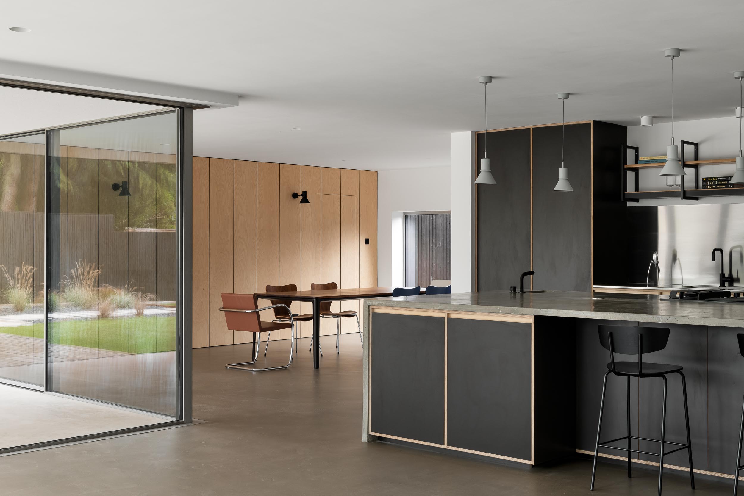 Modern open-concept space with large windows for intimate meetings and small events.