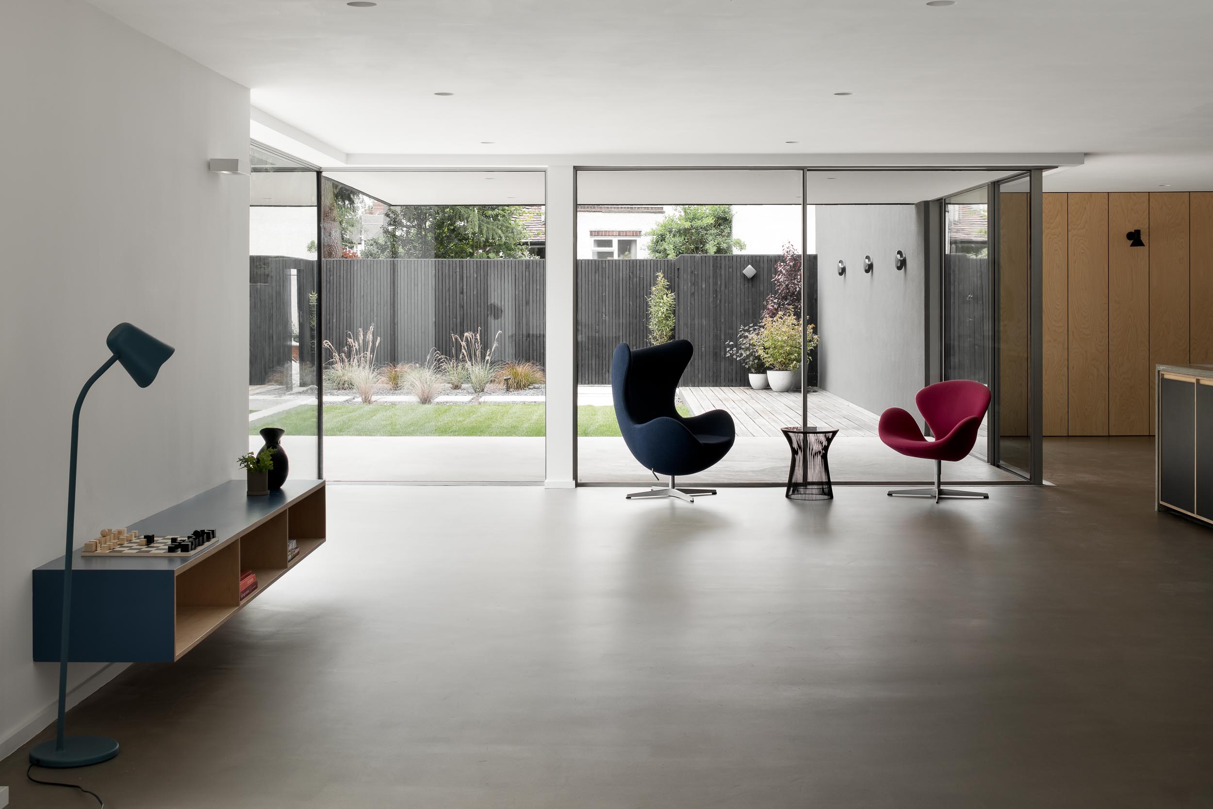 Modern minimalist event space with large windows for intimate meetings and gatherings.