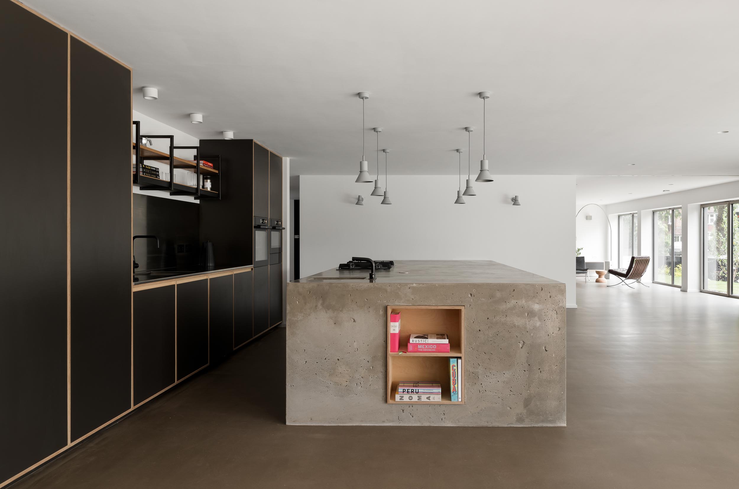 Modern minimalist kitchen with central island, ideal for networking events and gatherings.