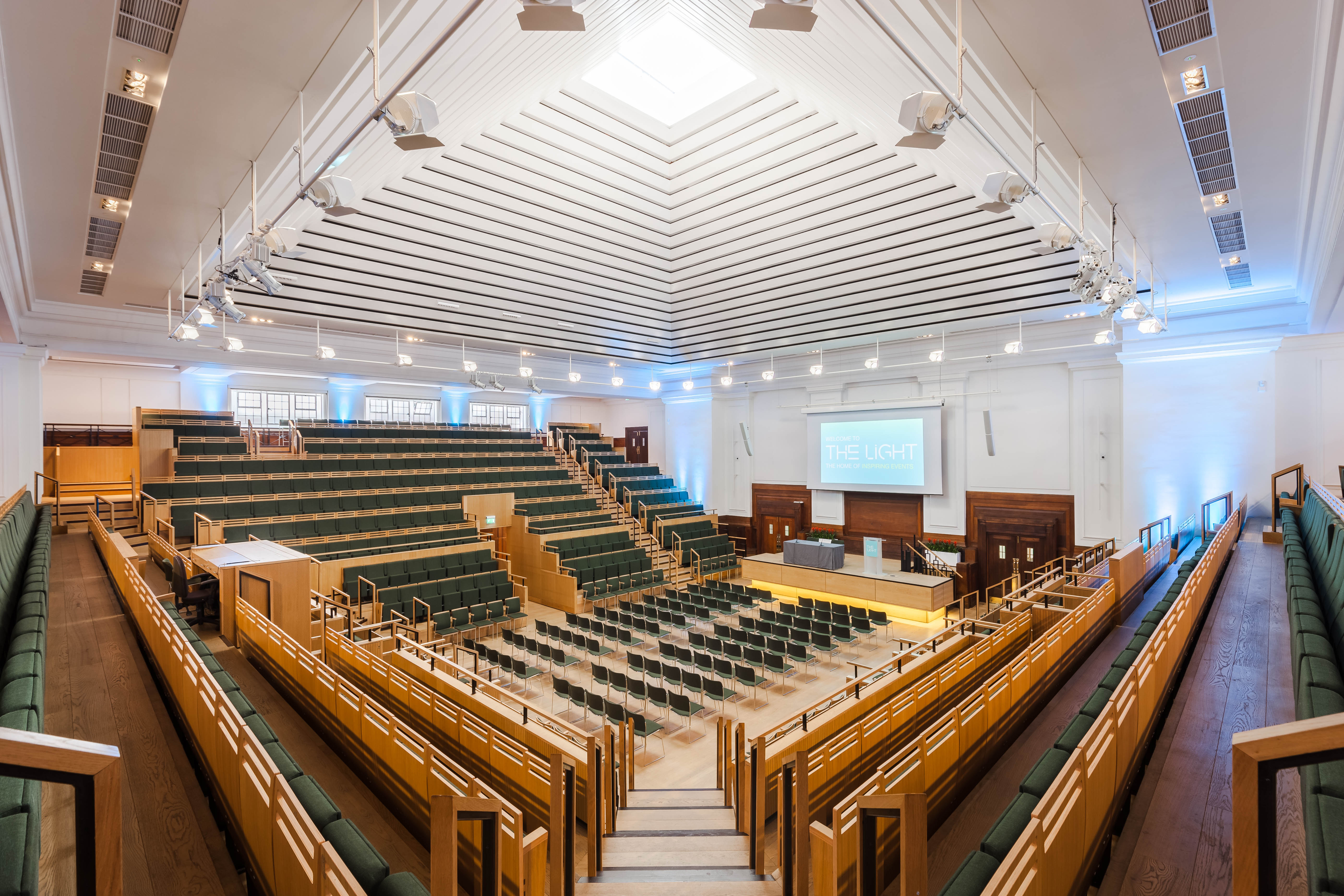Modern auditorium with tiered seating for meetings and conferences in Friends House.