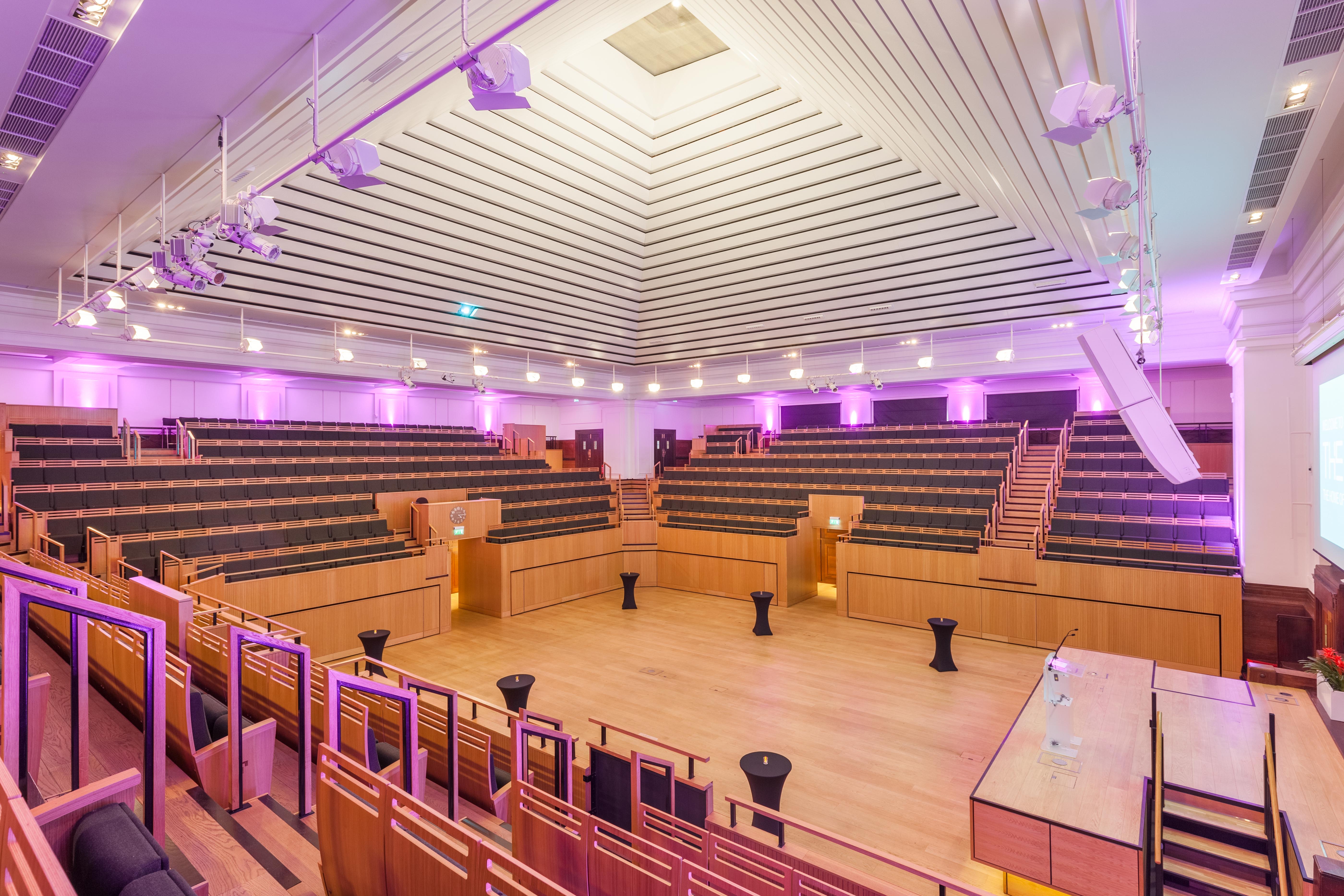 Spacious auditorium with tiered seating for events and meetings at Friends House.