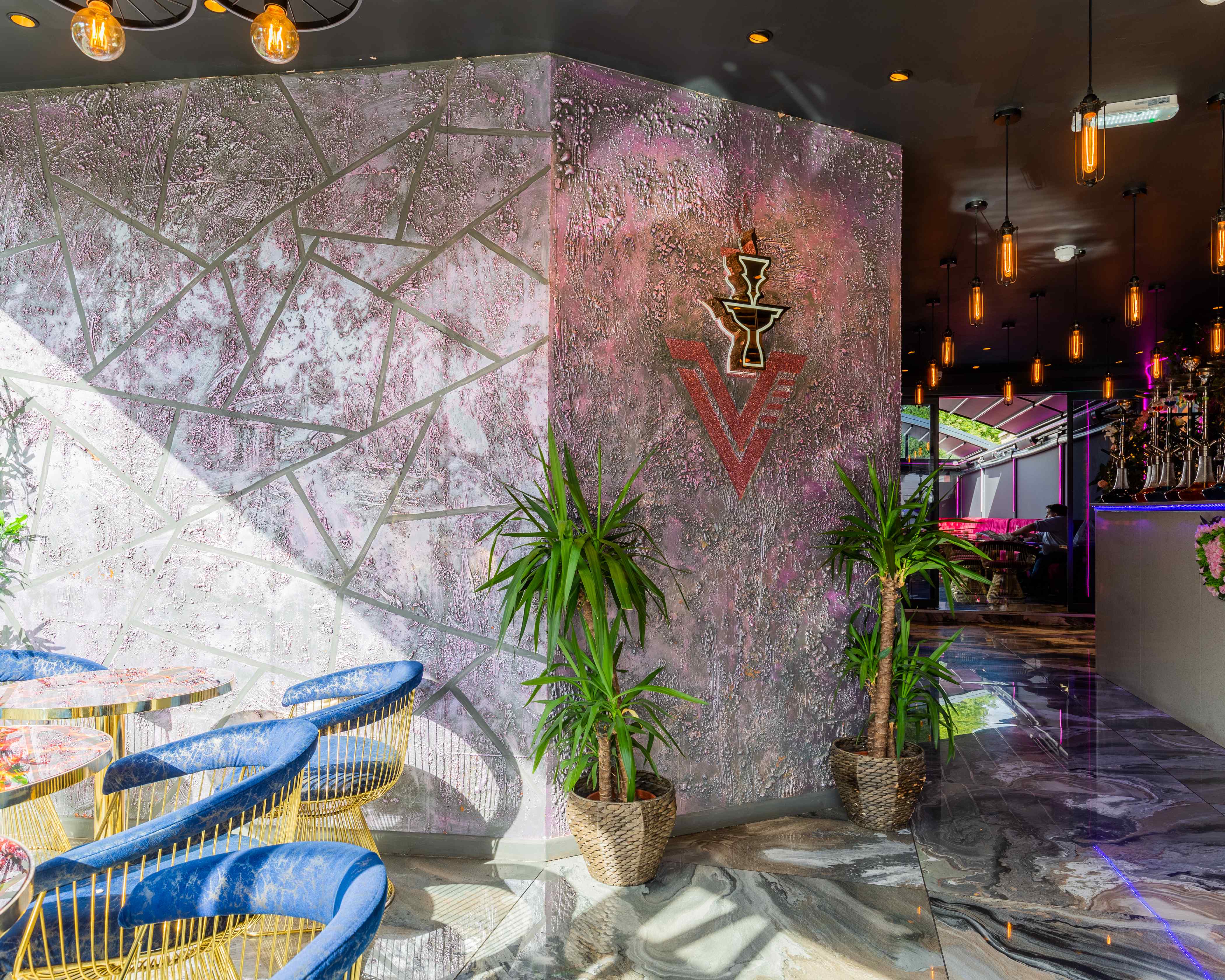 Stylish Vogue Lounge event space with textured wall, ideal for networking and gatherings.