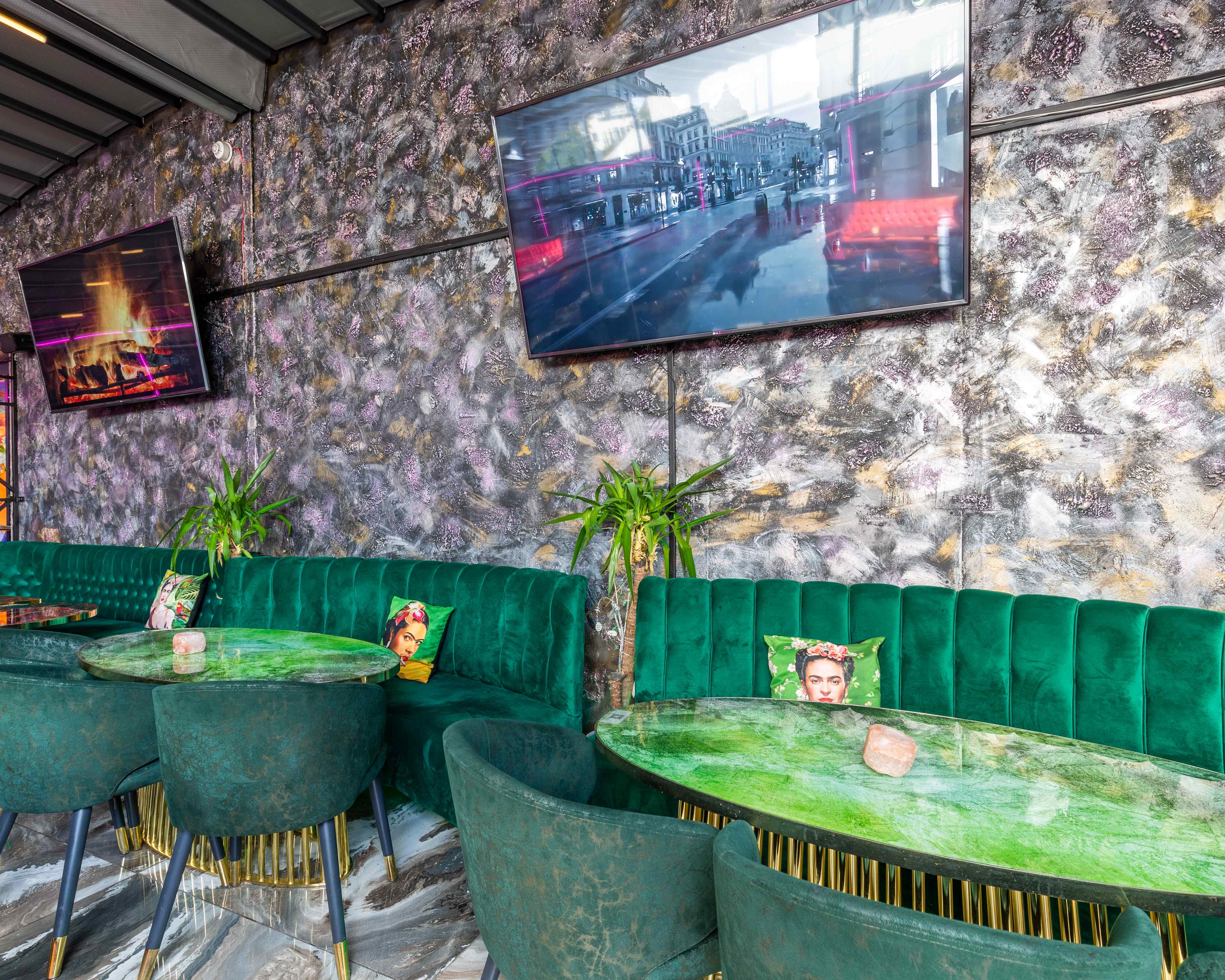 Stylish Vogue Lounge with plush green seating, perfect for networking events and gatherings.