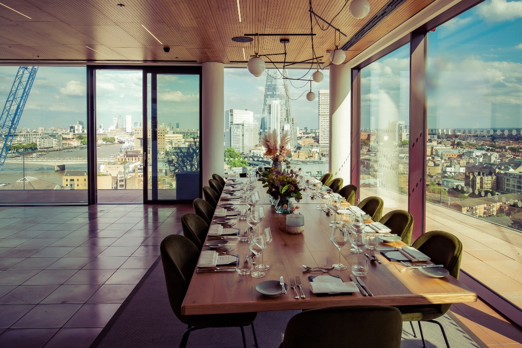 Private dining room with elegant table and city views for corporate events.