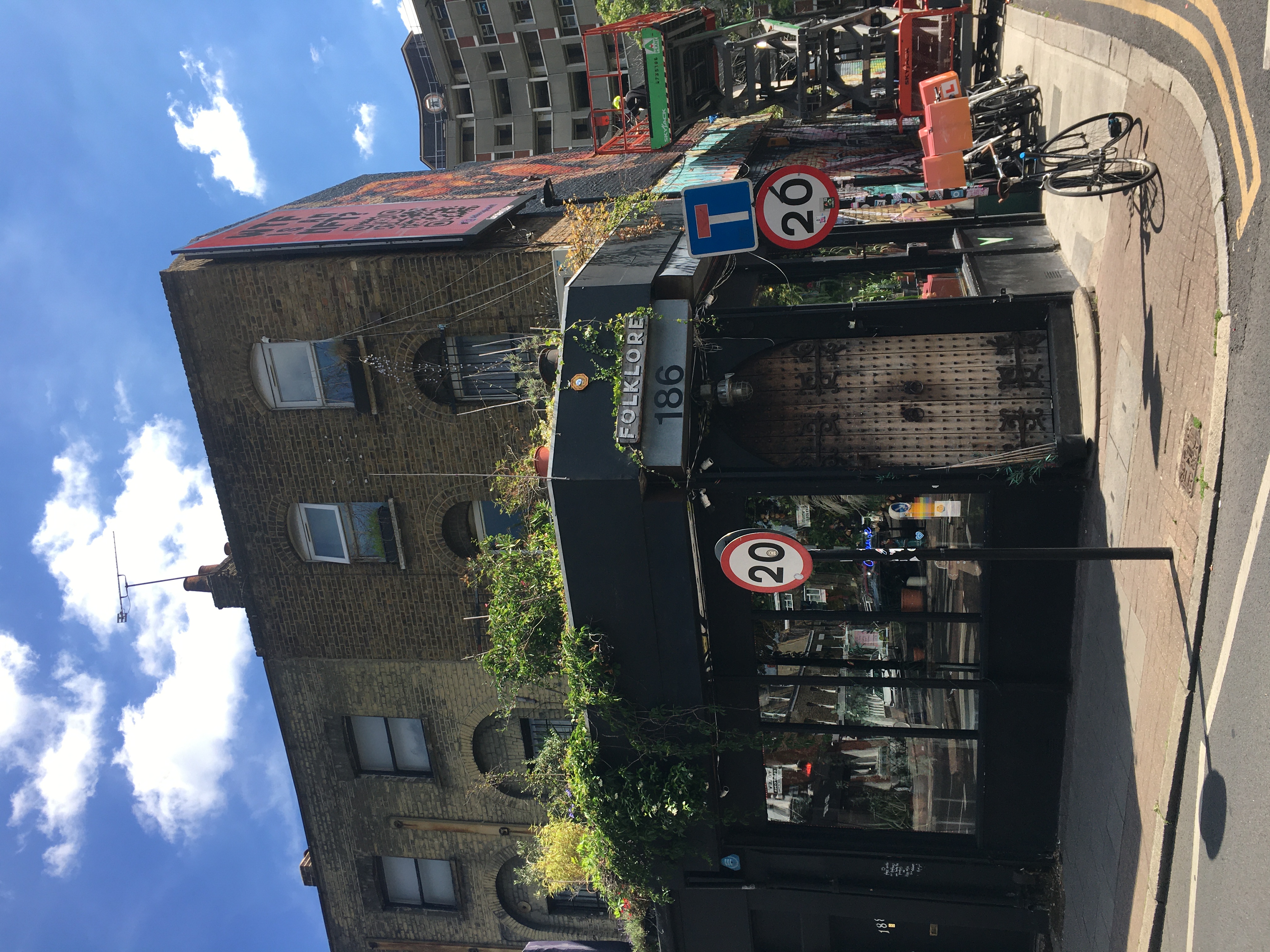 Charming Folklore venue exterior with greenery, ideal for networking events and workshops.