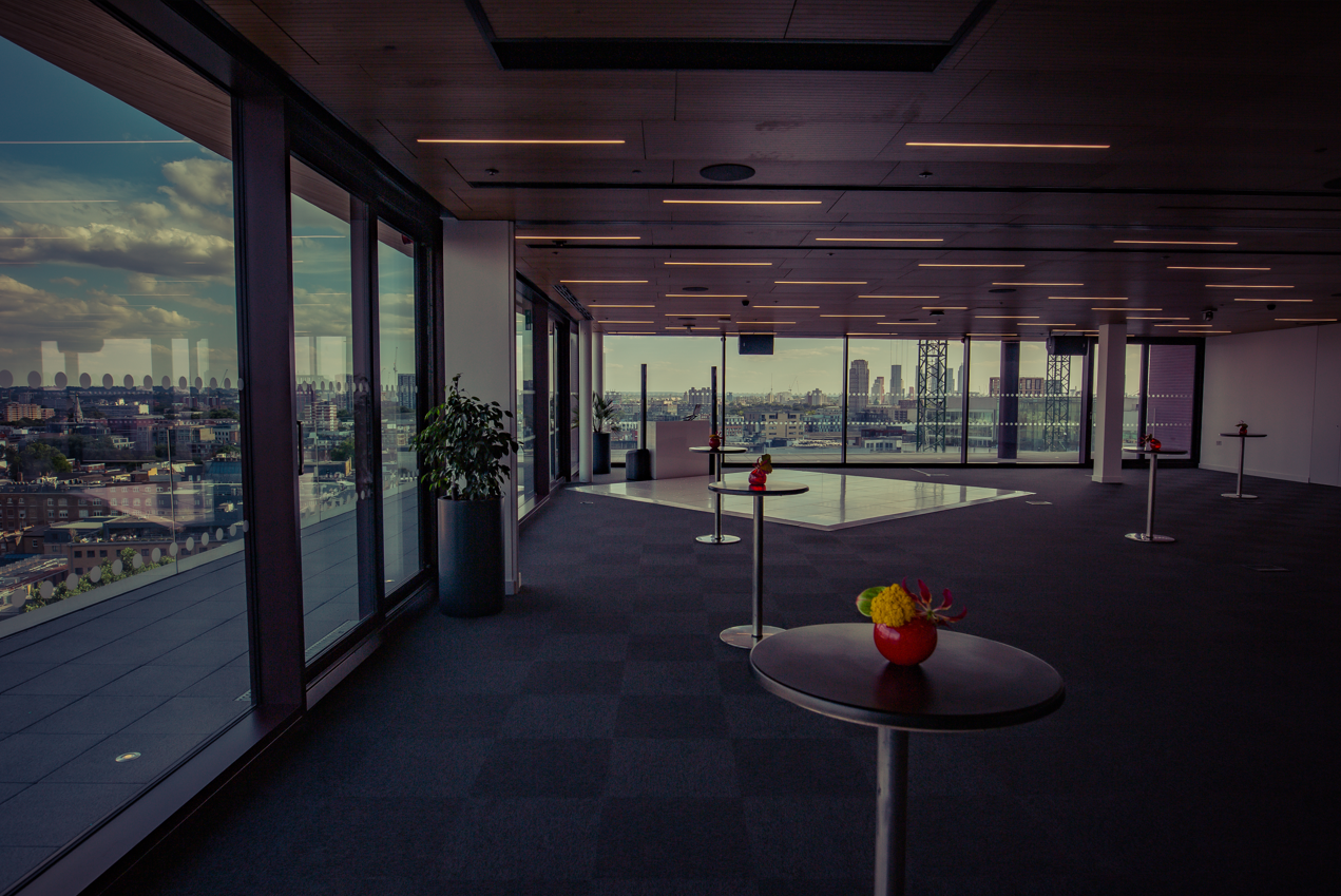 Modern event space with large windows, perfect for networking and receptions in Rose Court.