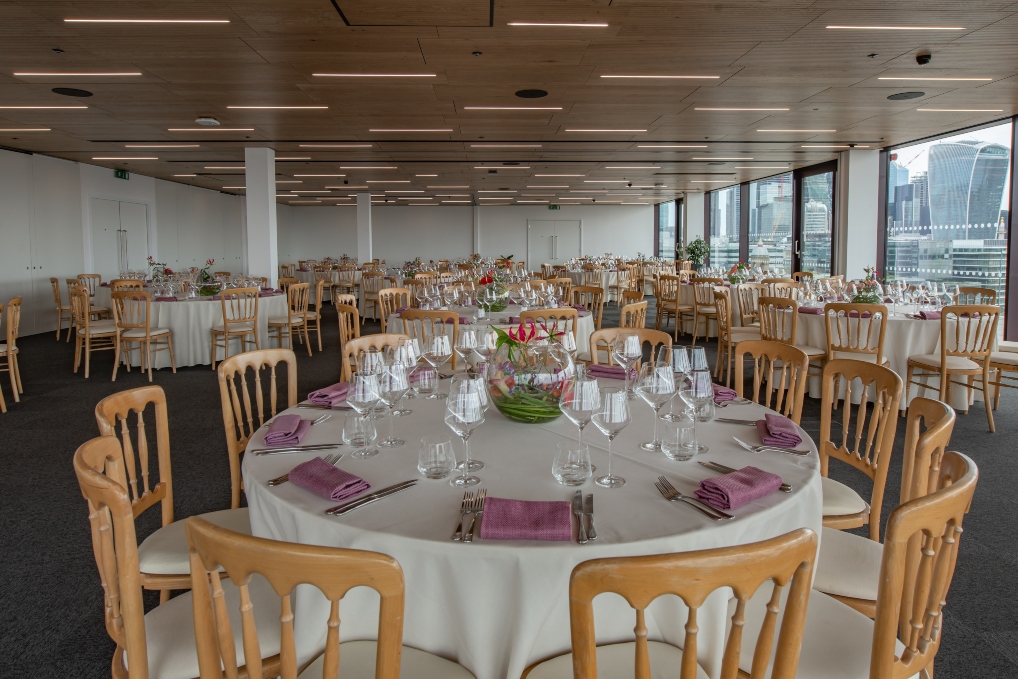 Elegant event space with round tables, perfect for weddings and corporate gatherings.