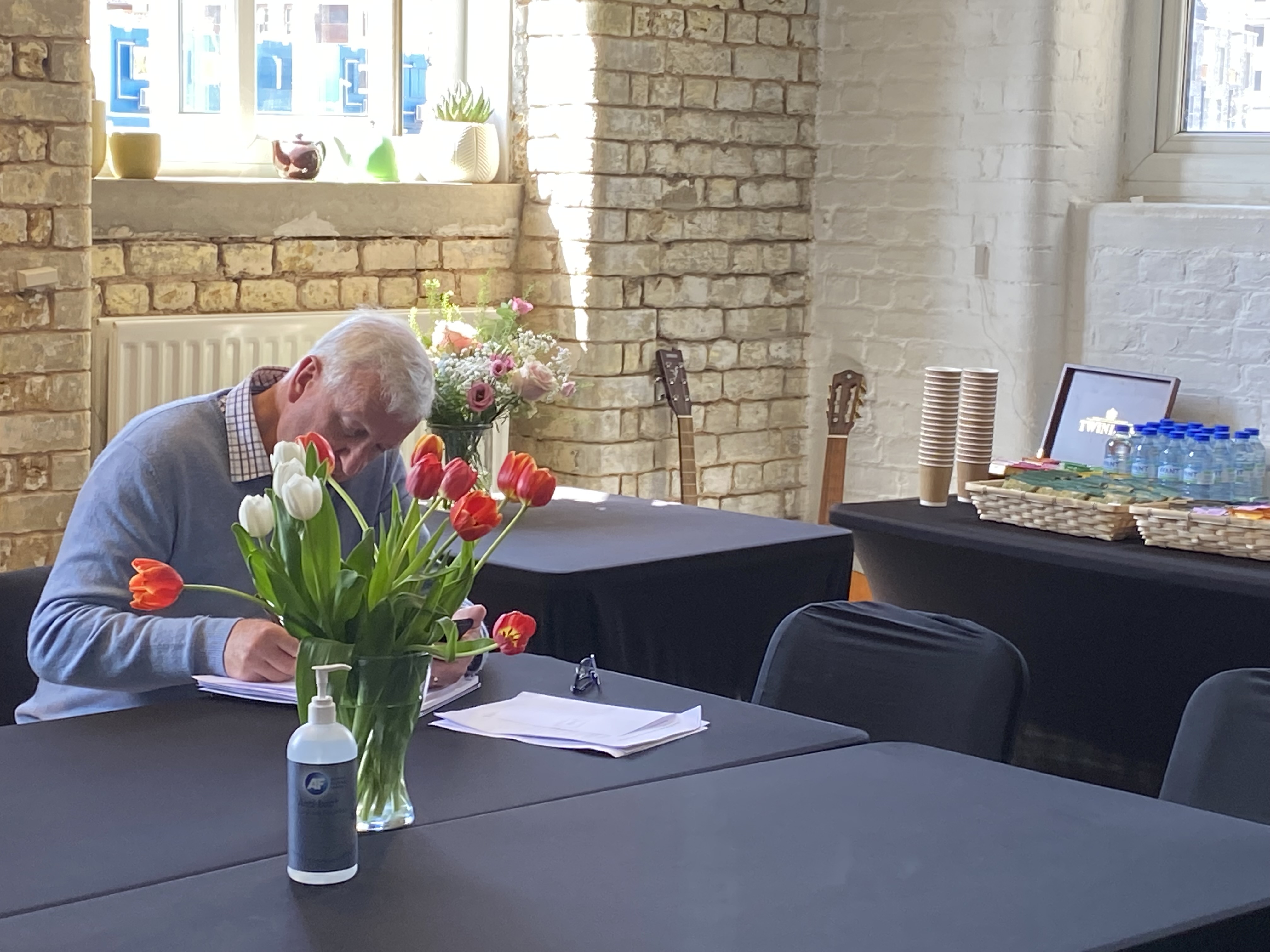 Randells Room at Boathouse Studios: professional meeting space with tulips and refreshments.