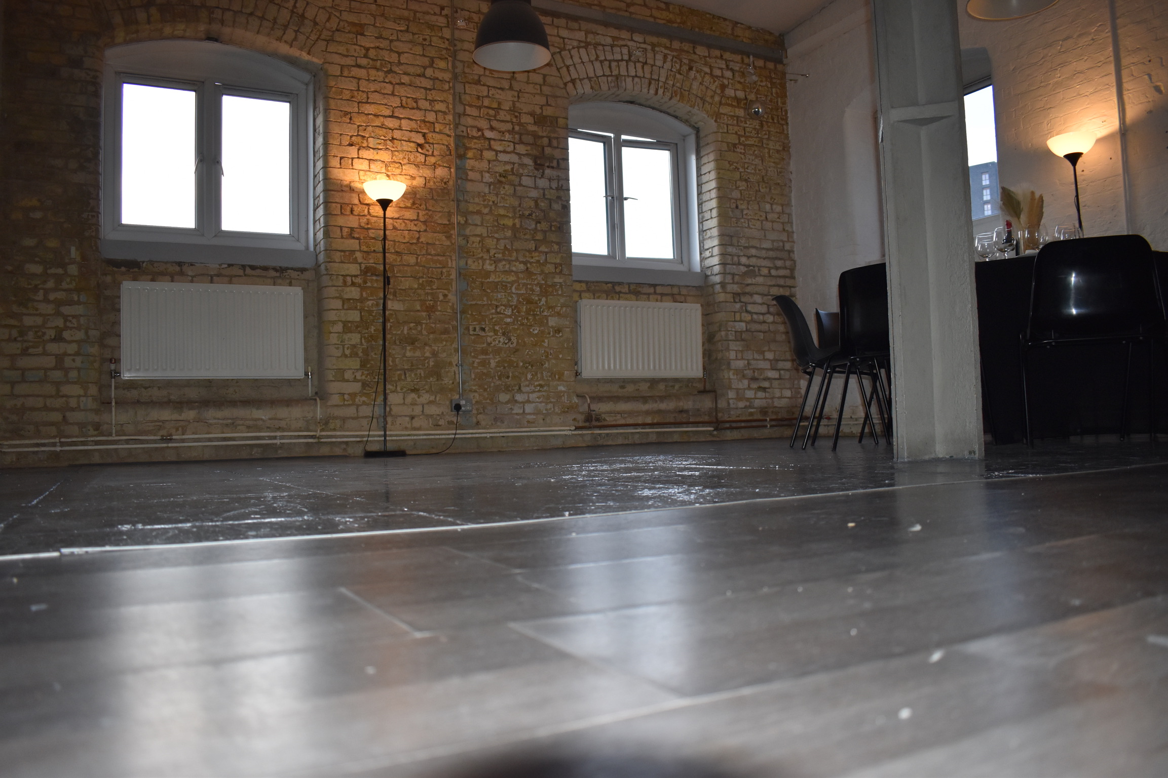 Versatile event space with exposed brick walls for networking events and workshops.