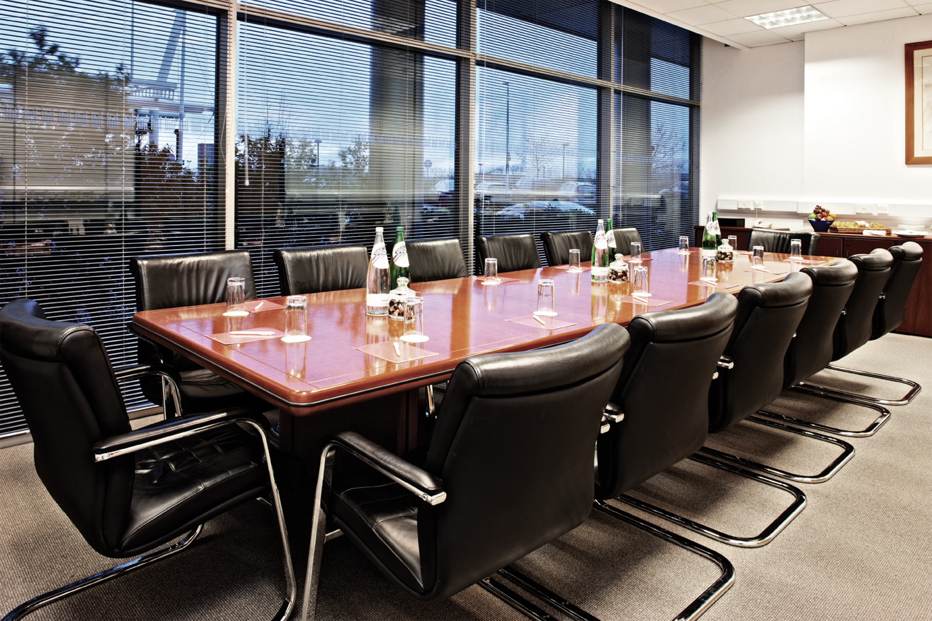 Madejski Suite conference room with wooden table, ideal for meetings and events.