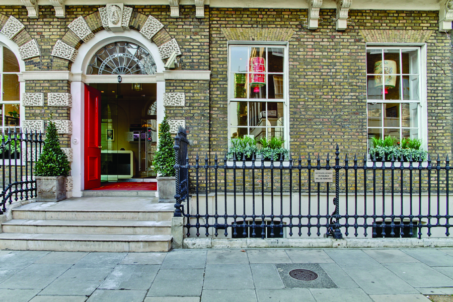 Christmas event at Asia House with a red door and inviting greenery for gatherings.