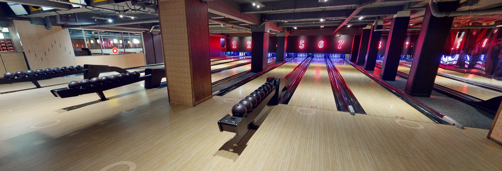 Modern bowling alley with vibrant lighting for corporate events and team-building activities.