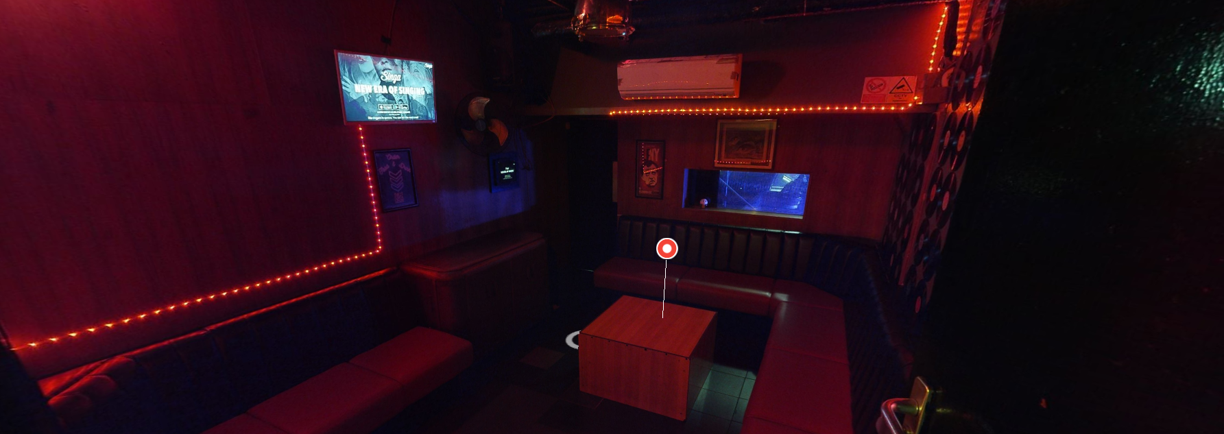 Cozy lounge with red lighting at Bloomsbury Bowling Lanes for networking events.