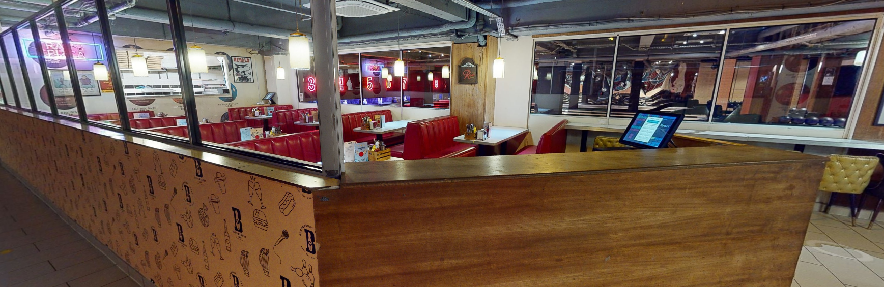 Cozy diner-style restaurant with red booths for casual dining and networking events.