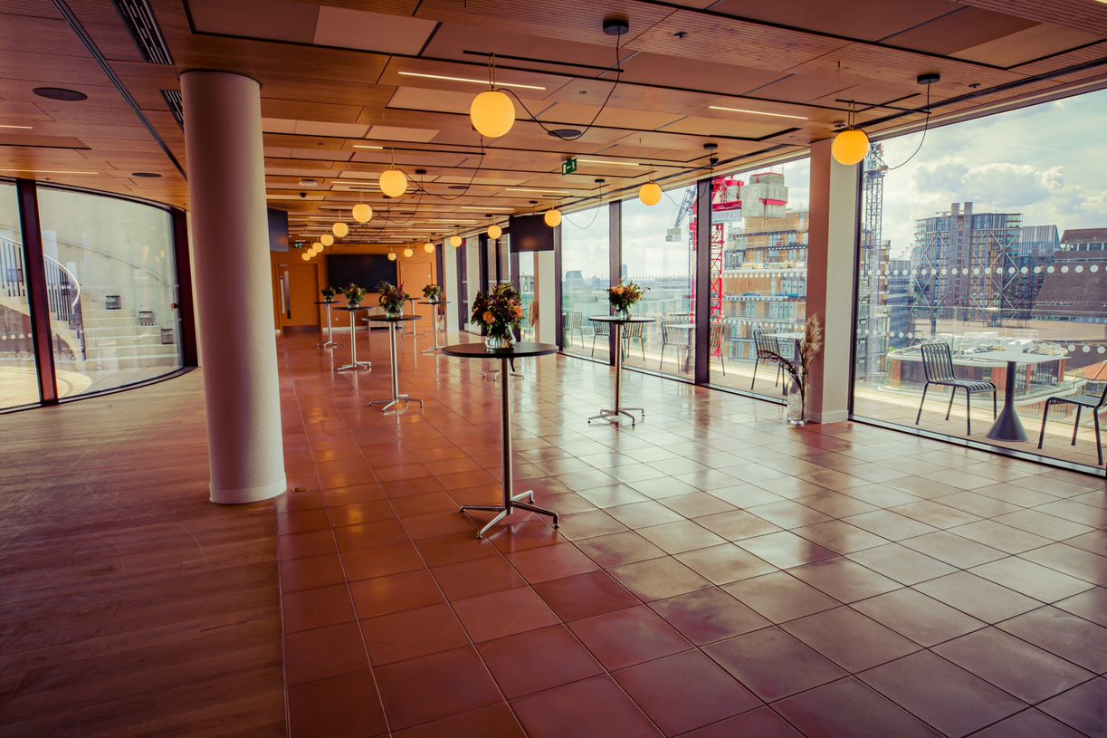 Spacious Rose Court event space with modern decor and city views for corporate gatherings.