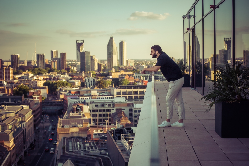 Professional reflecting on rooftop terrace at The Circle, Rose Court Events, ideal for networking.