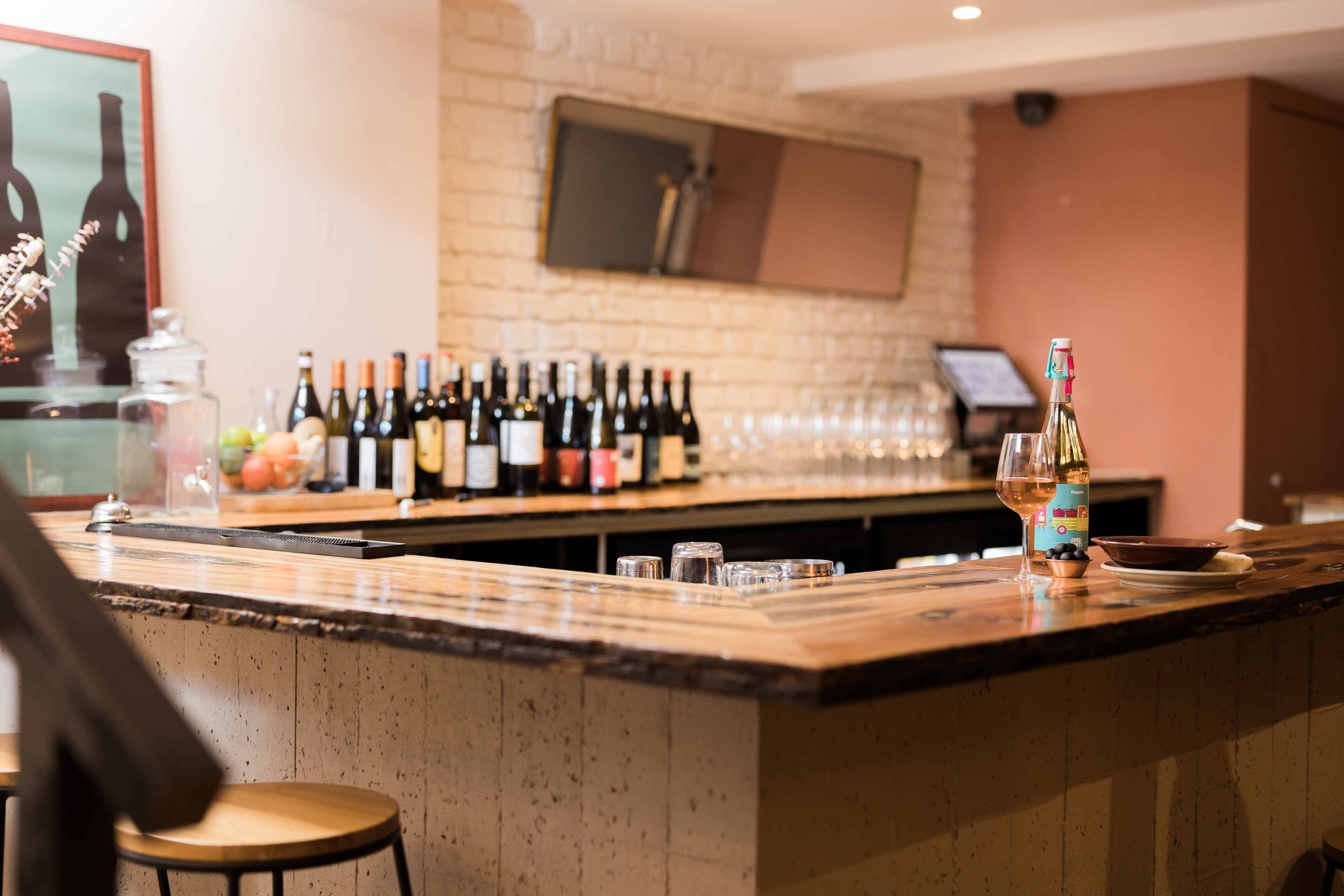 Sohaila's elegant bar area with curated wine selection for networking events.