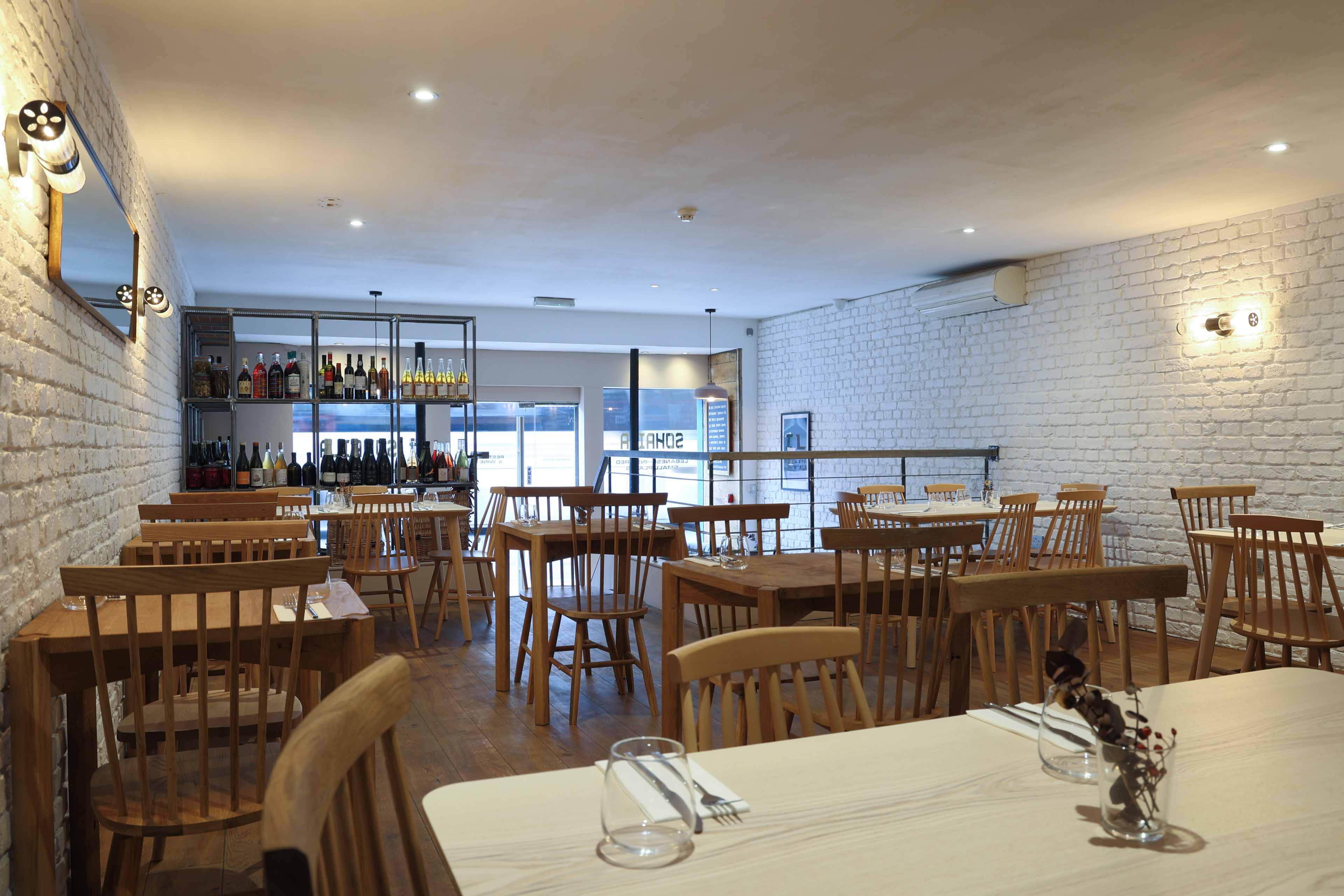 Modern dining space with wooden furniture for intimate gatherings and corporate events.