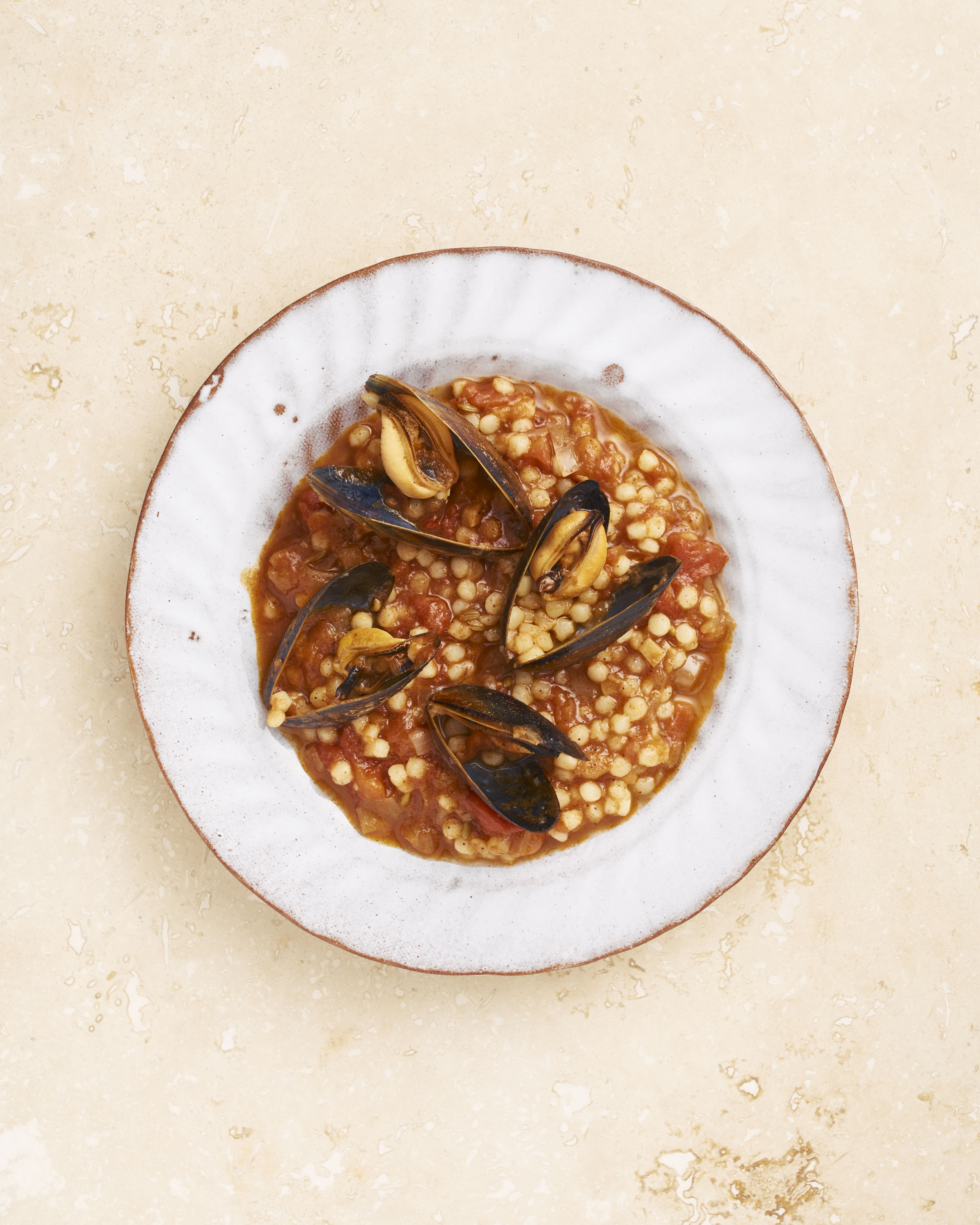 Gourmet mussels dish on grain, perfect for upscale culinary events and banquets.