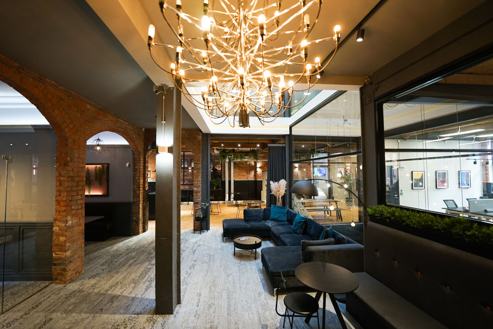 Modern meeting room with chandelier, ideal for events and gatherings.