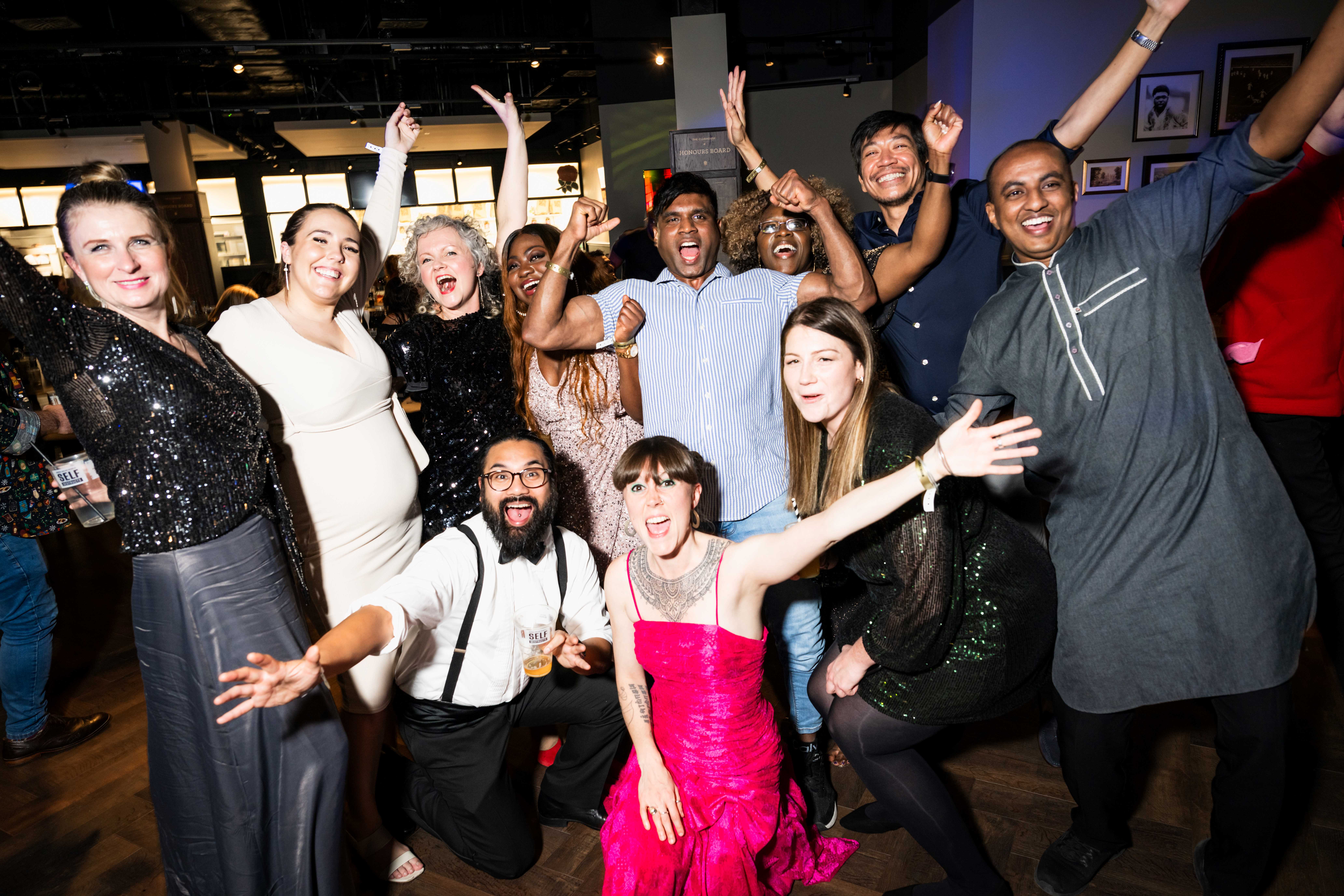 Christmas party celebration at Allianz Stadium, Twickenham with joyful attendees.