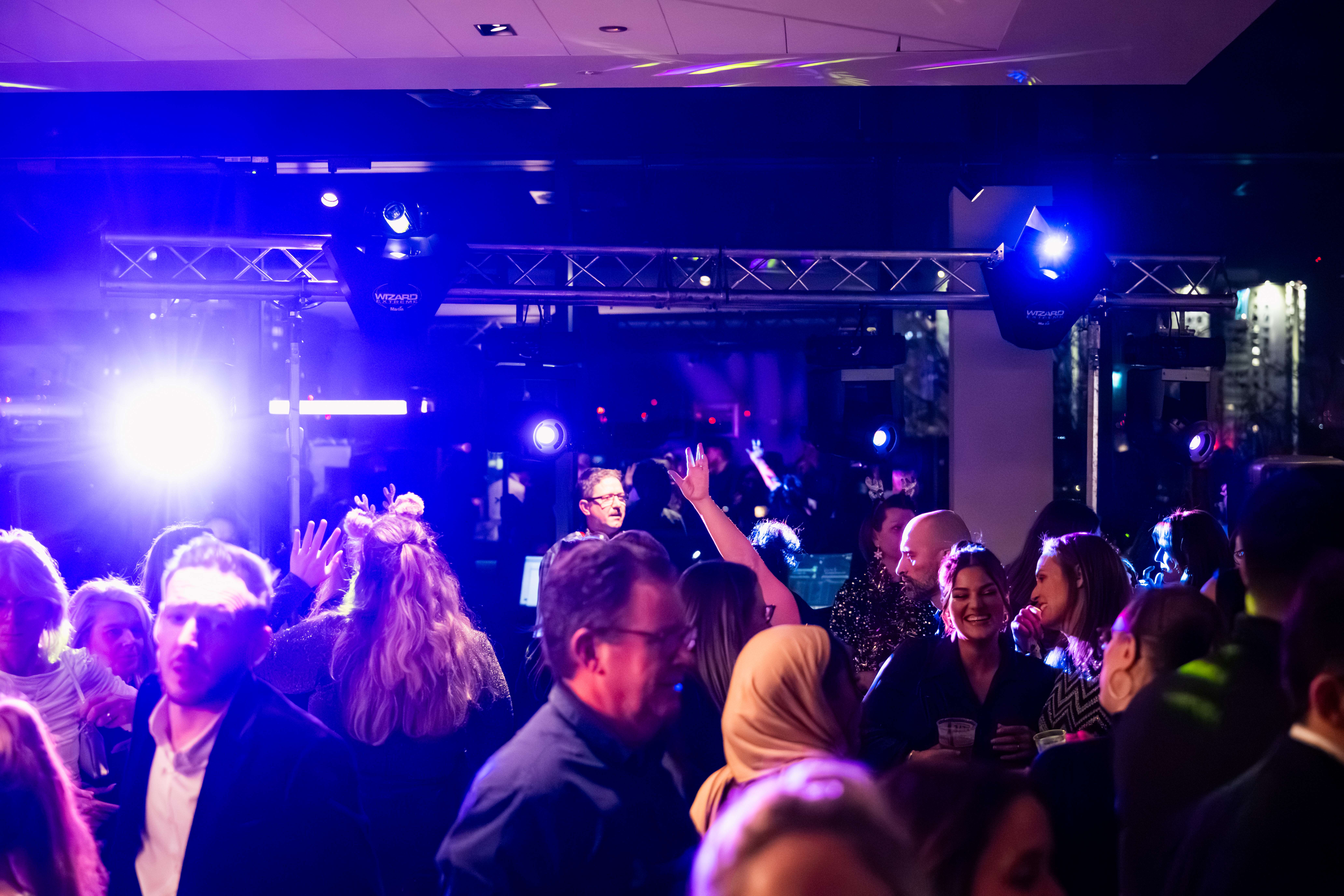 Christmas party at Allianz Stadium, Twickenham with vibrant atmosphere and dynamic lighting.
