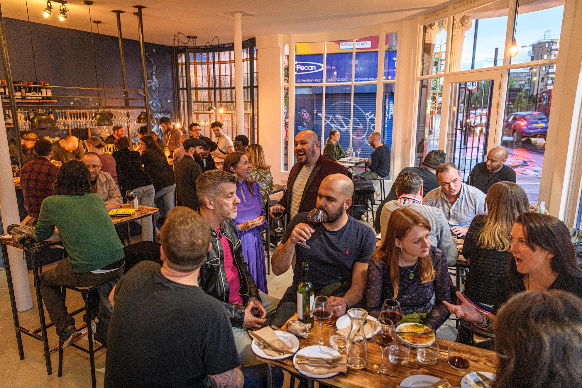 Vibrant networking event at The Tapas Room Peckham with communal tables and warm lighting.