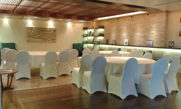 Elegant meeting space with round tables at Sofitel Dubai The Palm for corporate events.