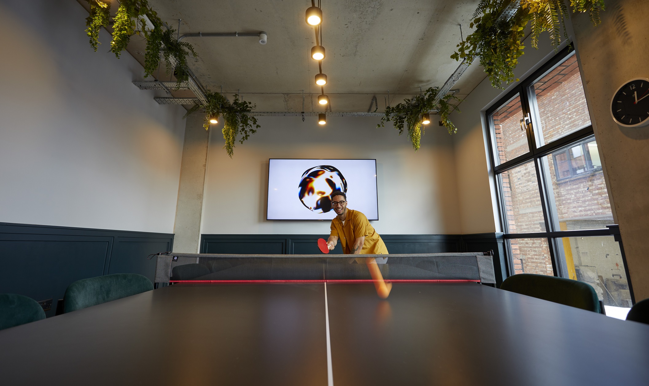 Modern meeting space with ping pong table for team-building and networking events.