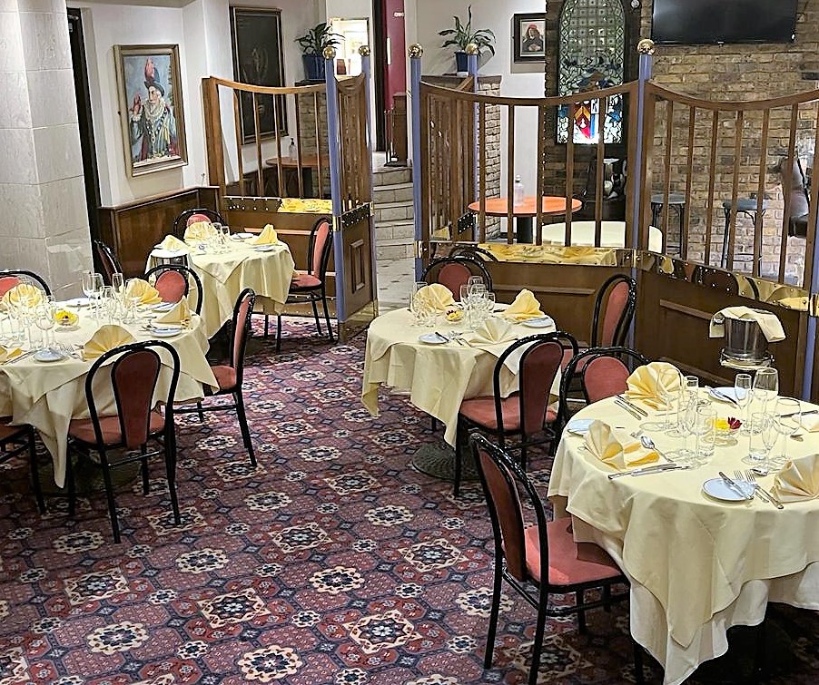 Elegant dining area with yellow tablecloths for upscale events in Bolton's Restaurant.