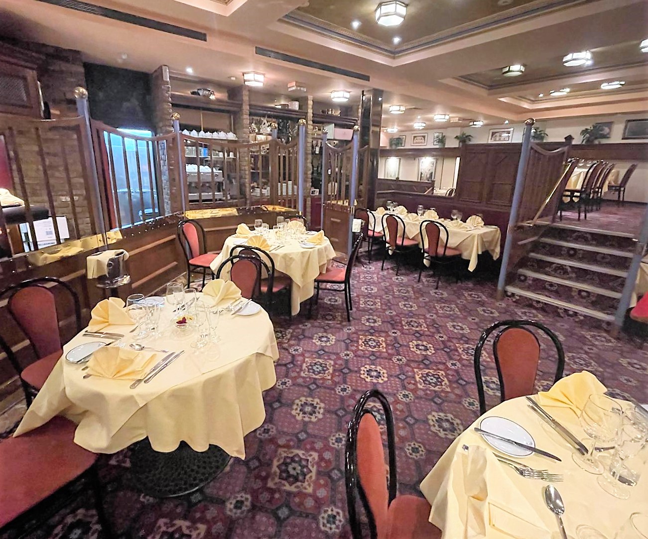 Elegant dining area with yellow linens for corporate dinners and intimate gatherings in Bolton.