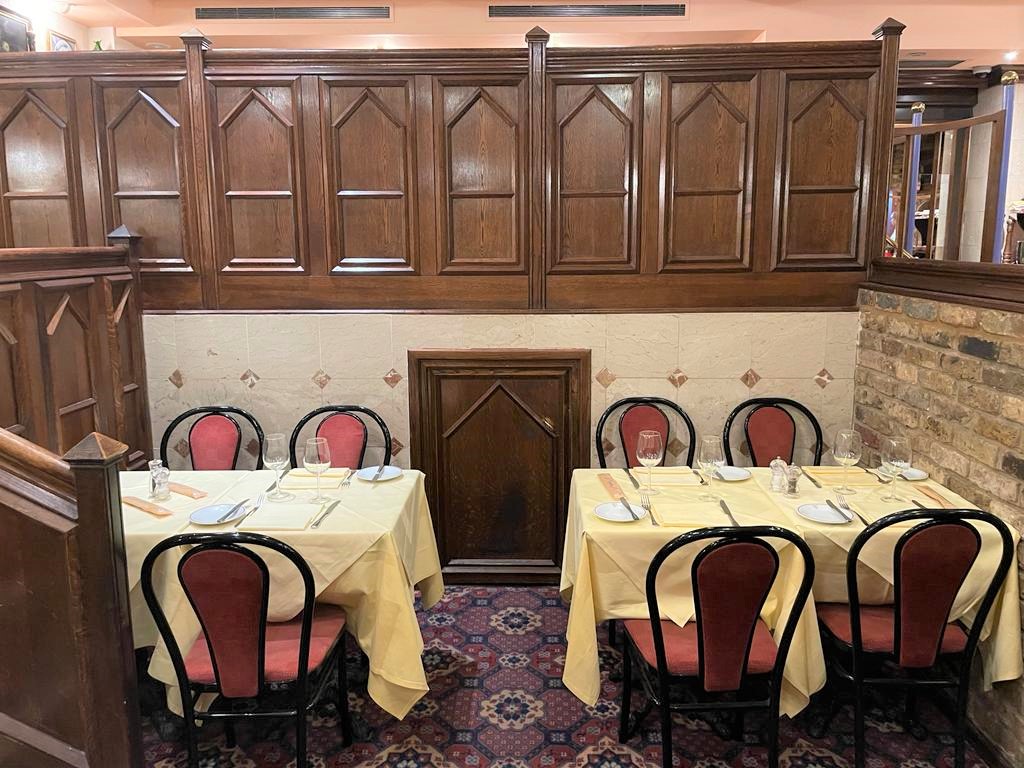Cozy dining setup with yellow tablecloths in Bolton's Exclusive Hire restaurant.