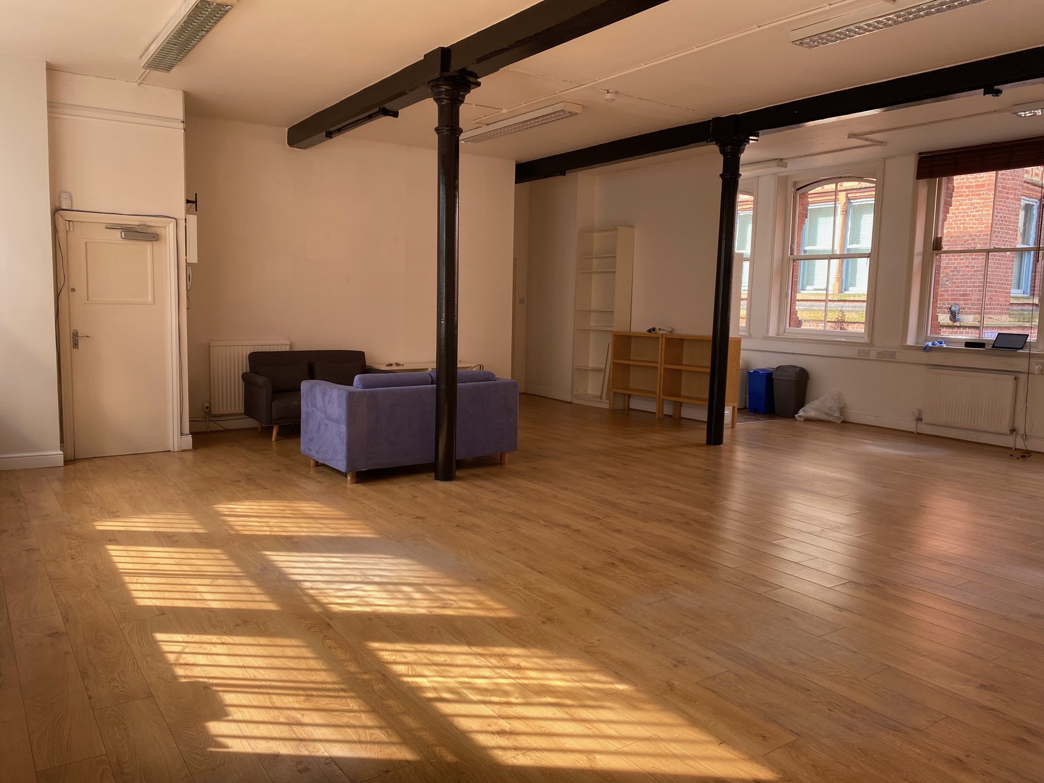 Spacious Tib Street Studio with wooden flooring, ideal for meetings and workshops.