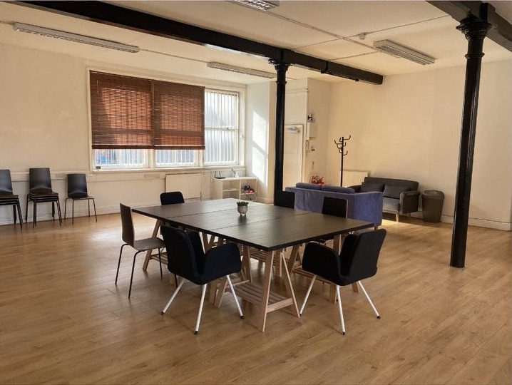 Tib Street Studio meeting space with large table, ideal for workshops and team meetings.