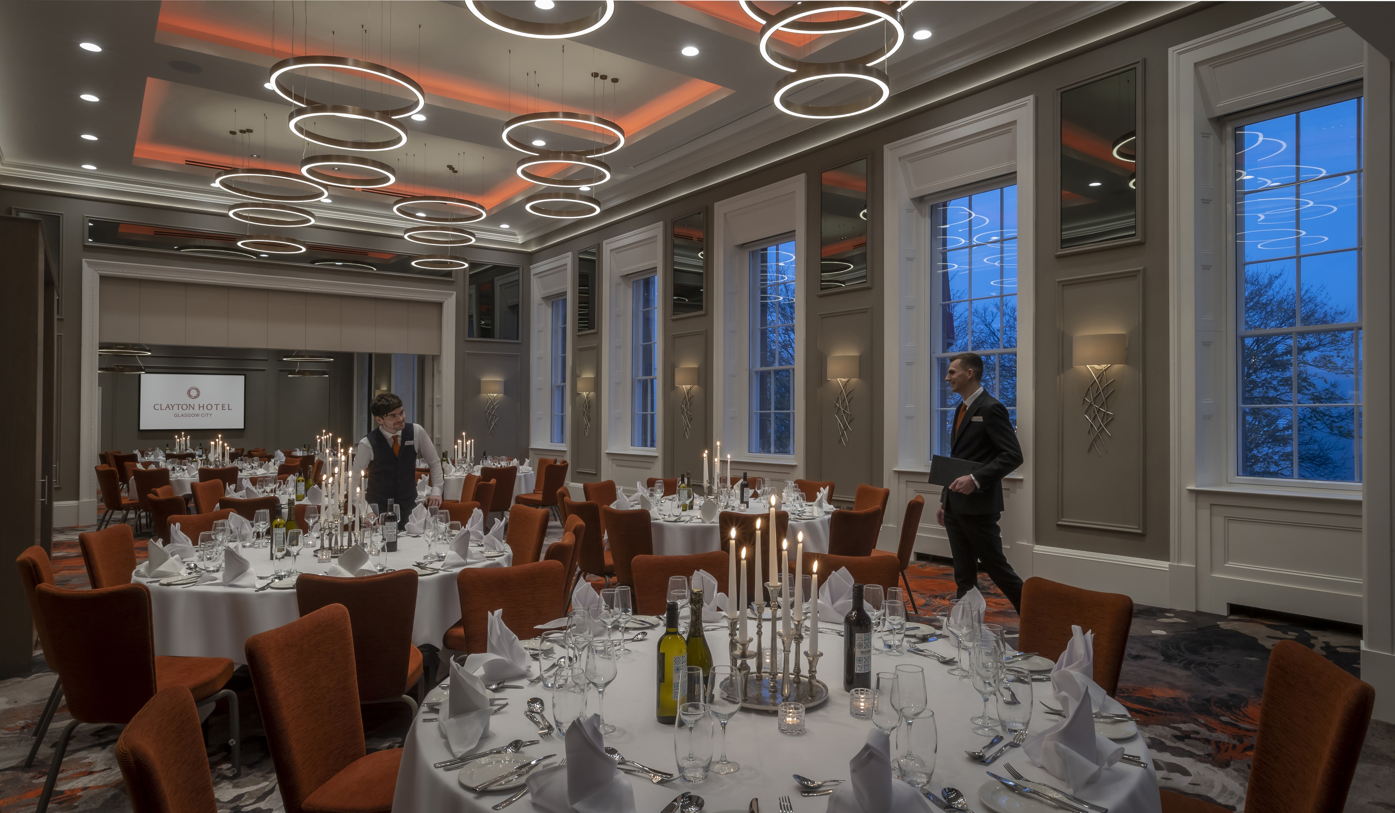 Elegant dinner setup at Custom House, Glasgow with round tables and stylish centerpieces.
