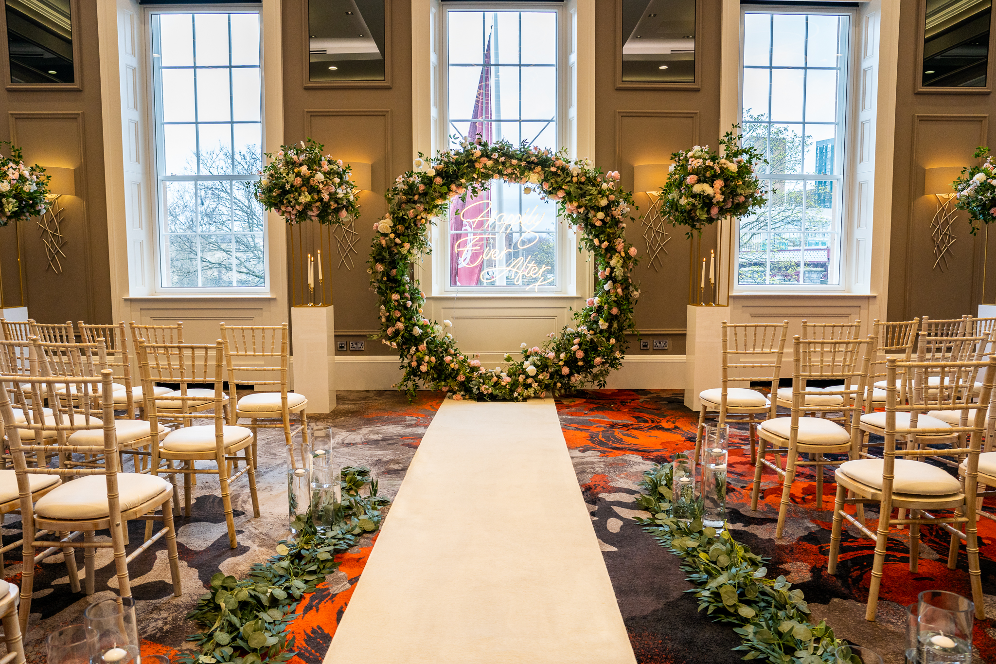 Custom House ceremony space with floral arch, ideal for weddings and formal events.