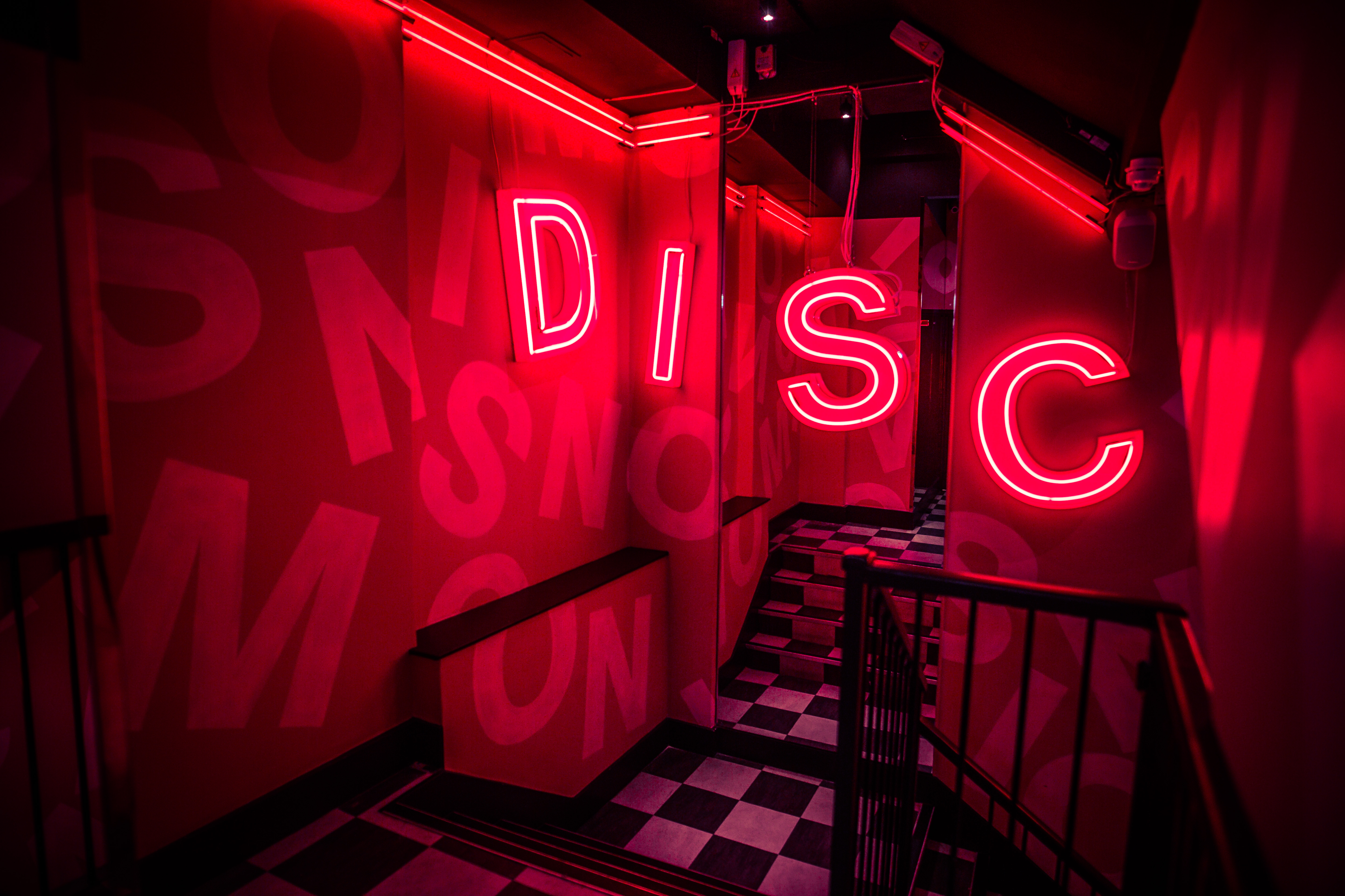 Vibrant neon-lit hallway at Simmons|Leicester Square for creative events and networking.