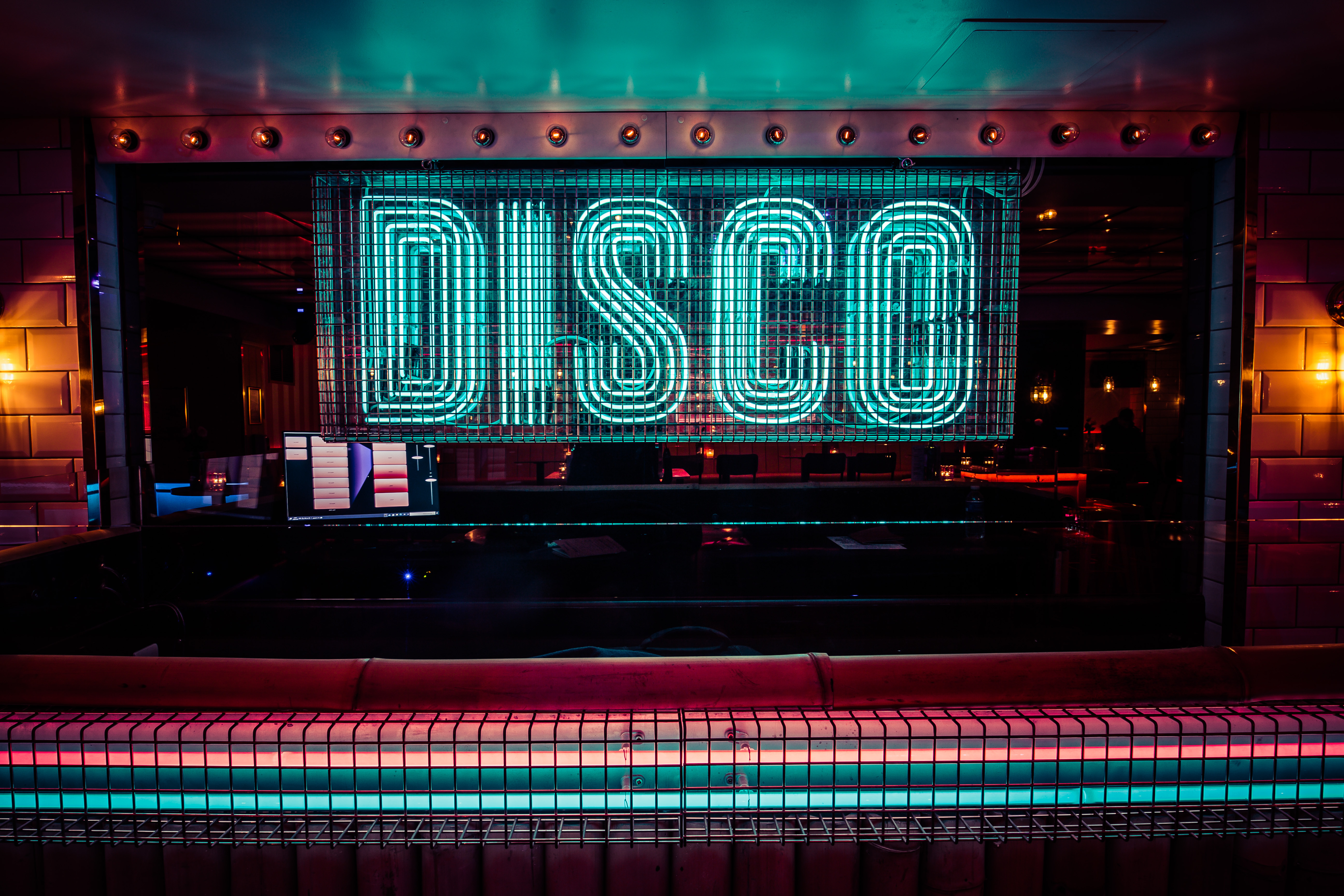 Vibrant neon "DISCO" sign at Simmons|Leicester Square for themed events and parties.