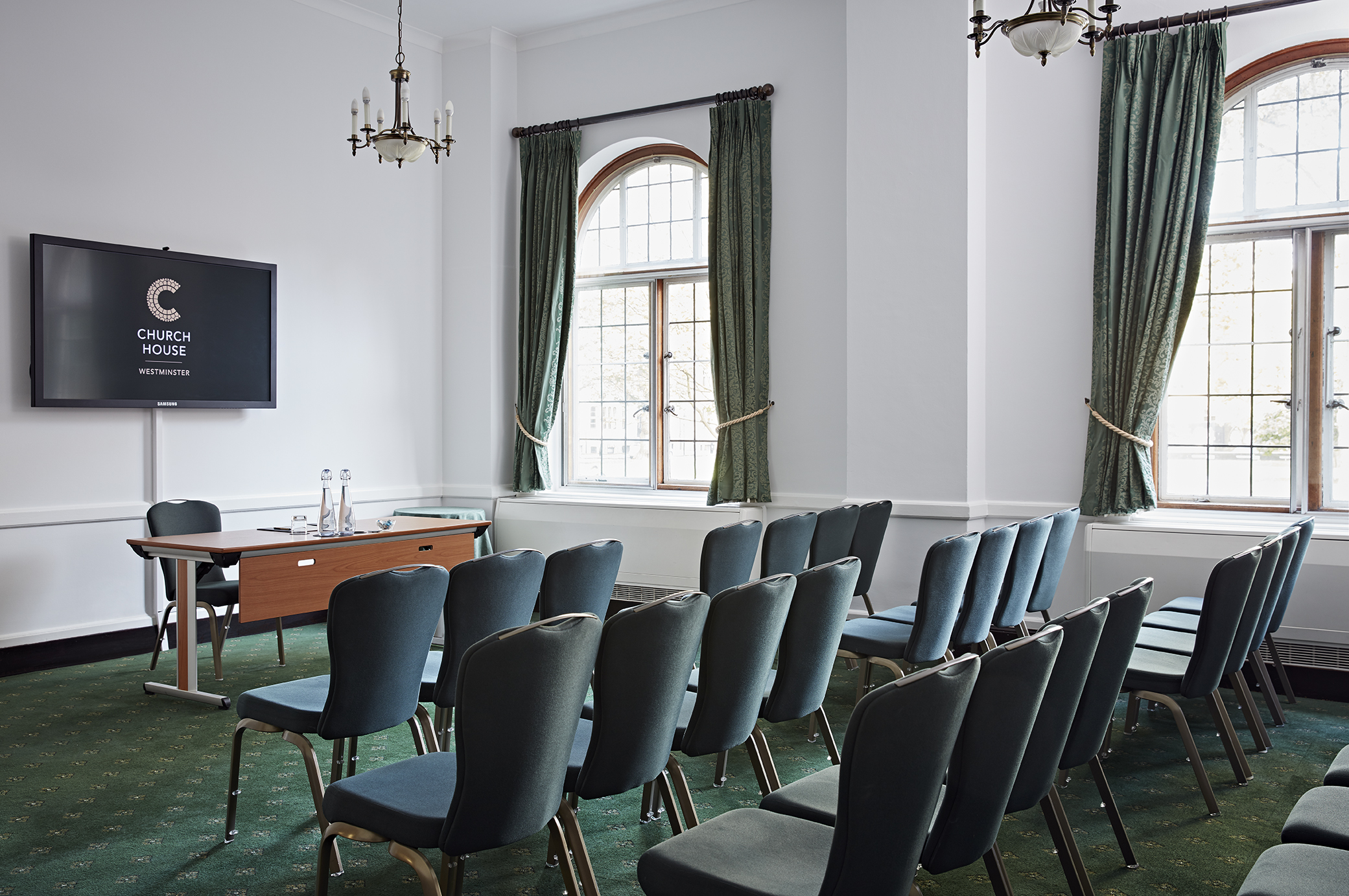 Westminster Room in Church House: elegant meeting space with natural light for events.