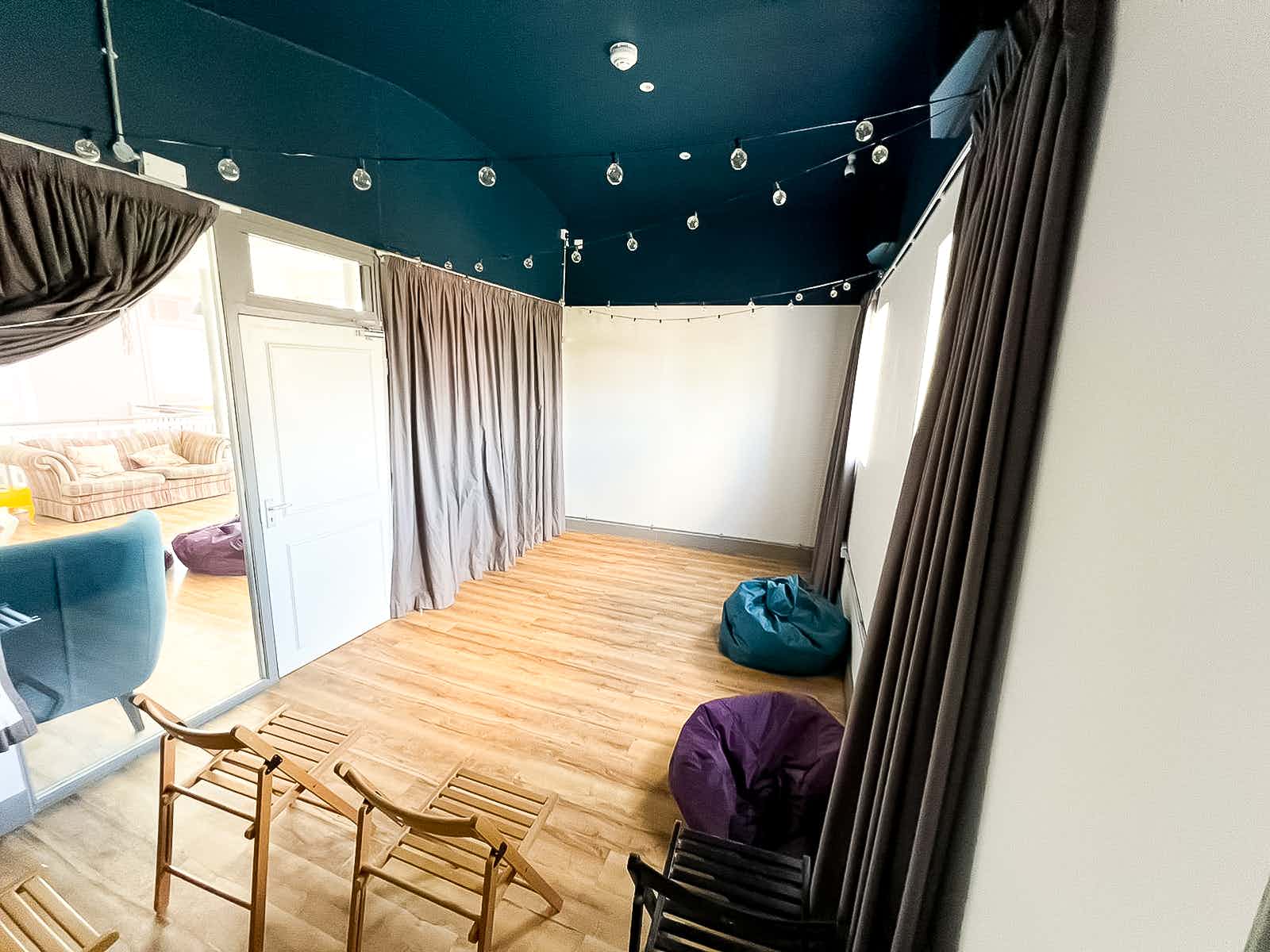 Cozy cinema room in Birmingham Selina for workshops and social events.