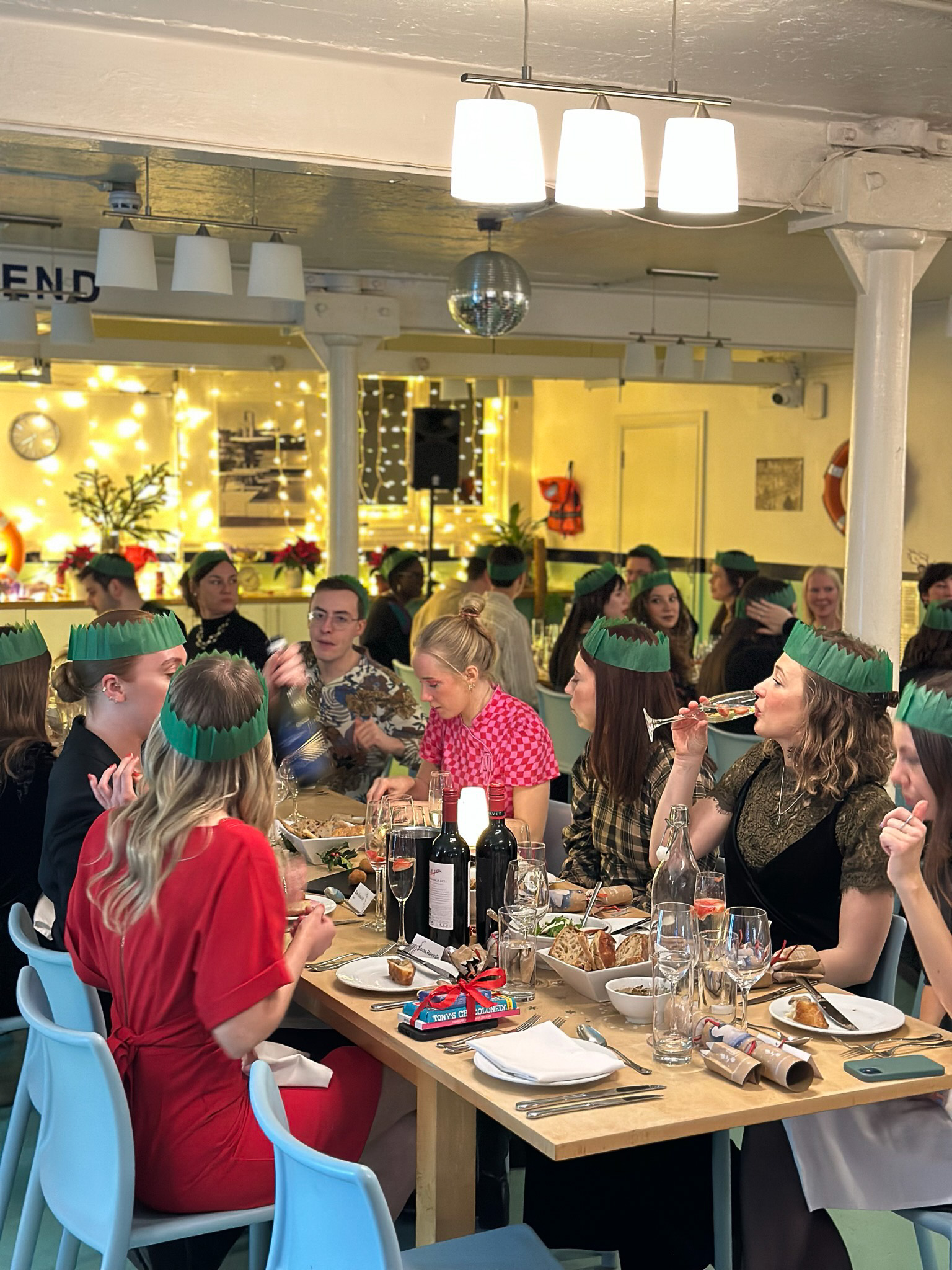 Lively dining event at Wallacespace St Pancras with festive decor and elegant table setting.