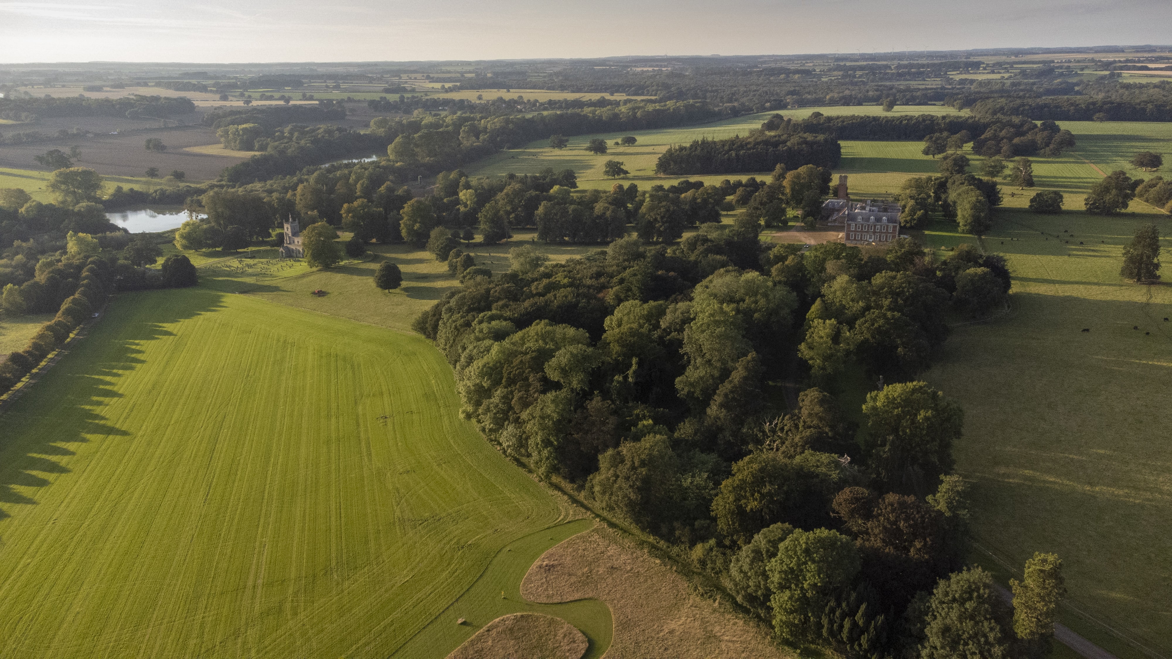 Raynham Park landscape with green fields, perfect for outdoor weddings and retreats.