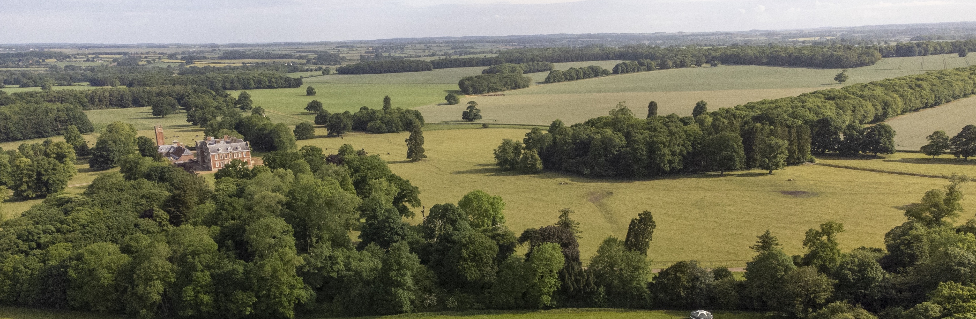 Raynham Park landscape with green fields, perfect for outdoor weddings and corporate retreats.