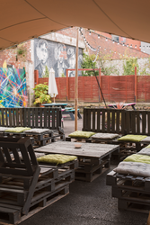 Vibrant Beer Garden in Liverpool Selina with rustic furniture, ideal for social events.