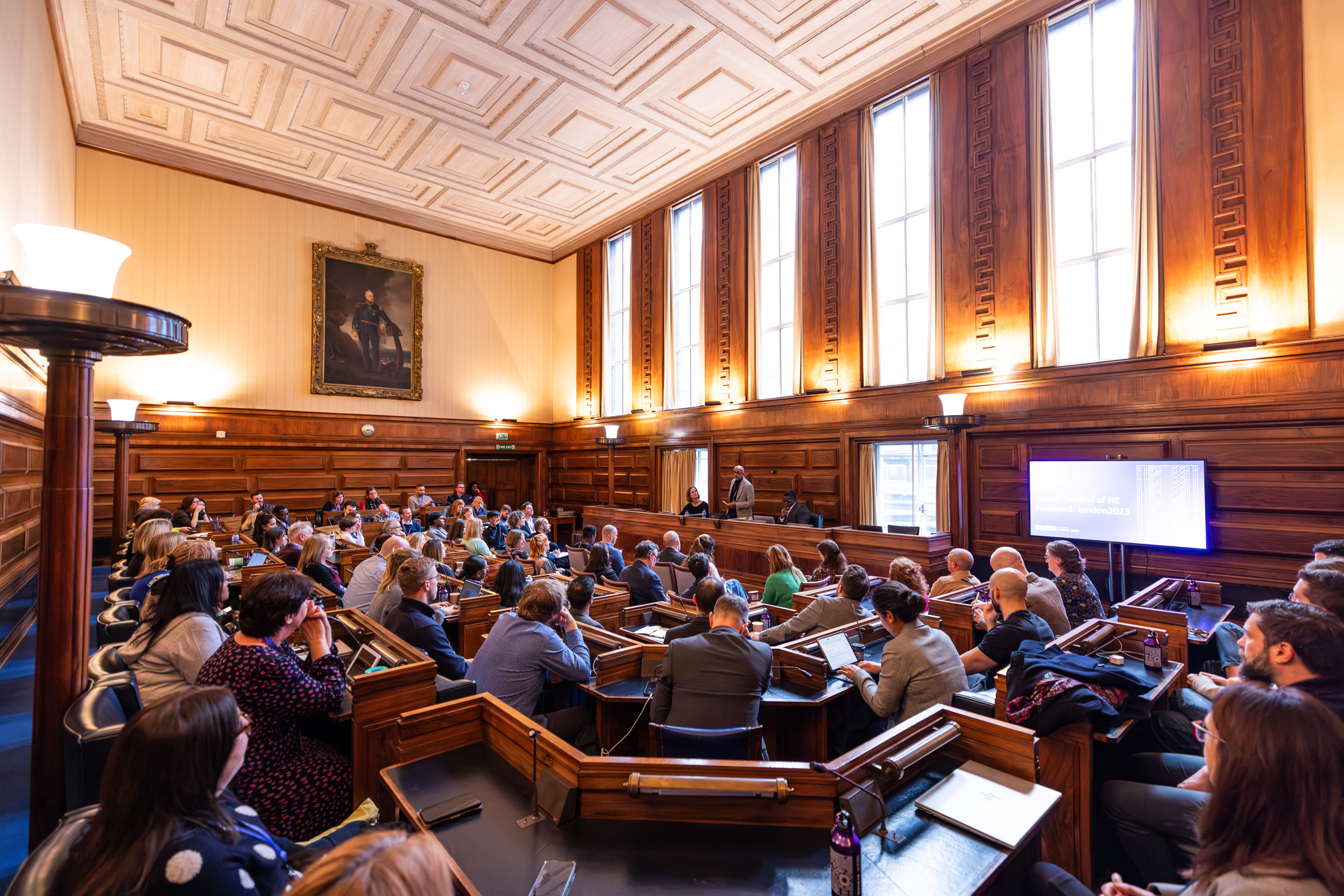 Senate Room conference at University of London, featuring engaged audience and speaker.