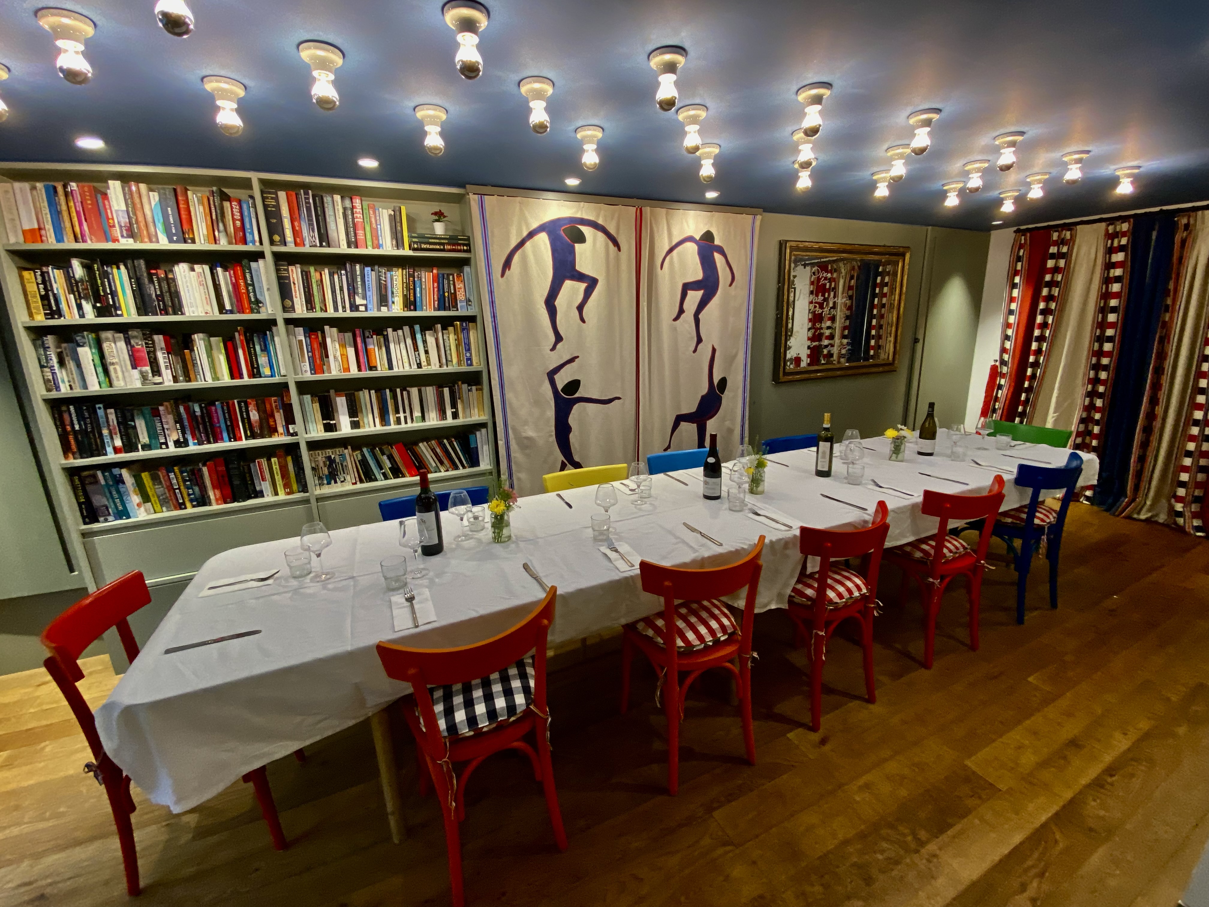 Private dining room at Sam's Cafe with colorful chairs, ideal for events and meetings.